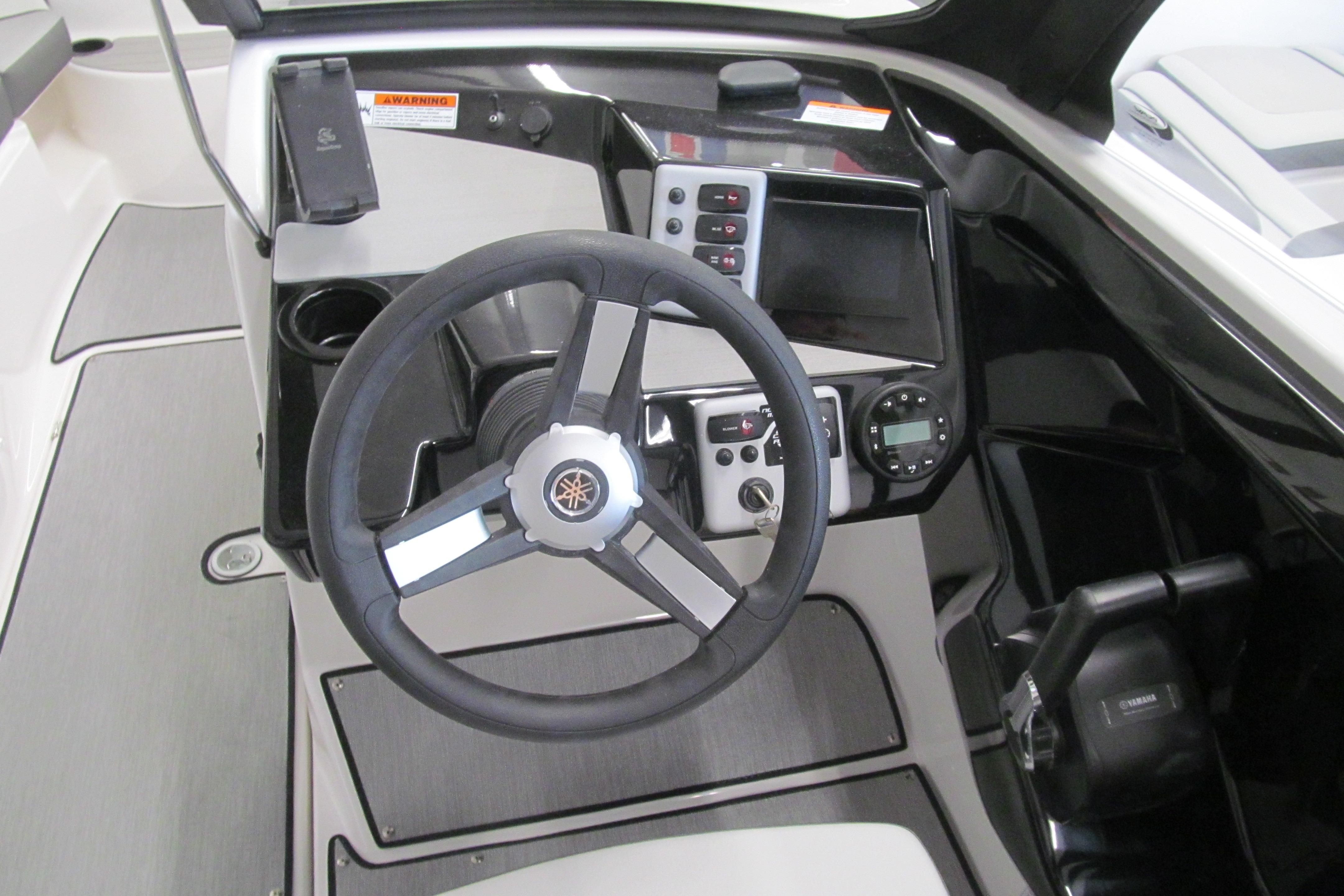 2026 Yamaha Boats AR220 cockpit with steering wheel and control panel.