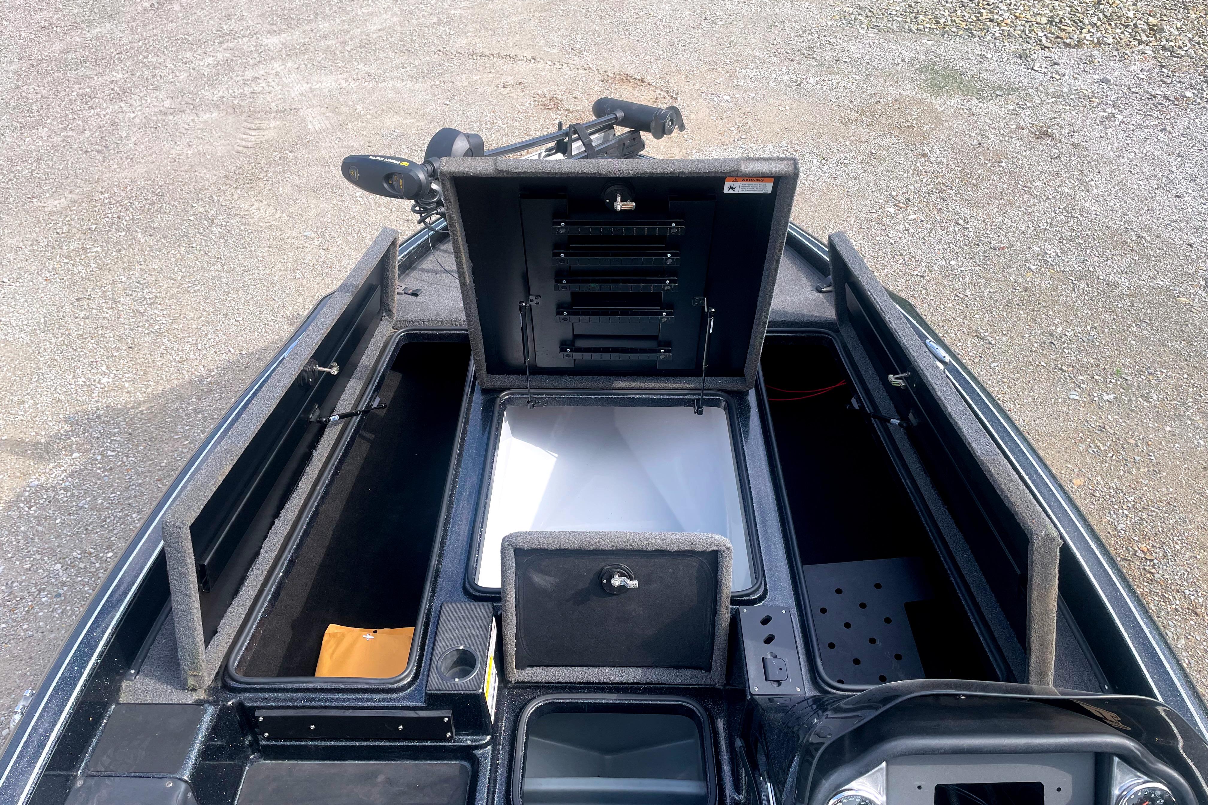 2022 Triton 18 TrX boat interior showing storage compartments and fishing rod holders.