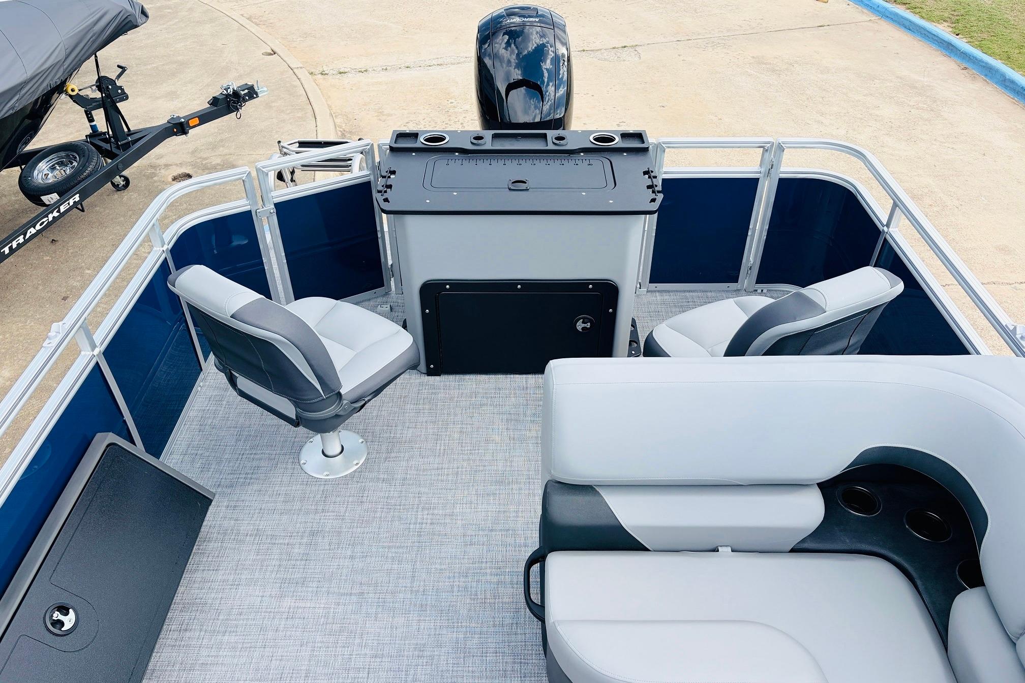 2026 Sun Tracker SportFish 22 DLX pontoon boat interior with seating and helm station.