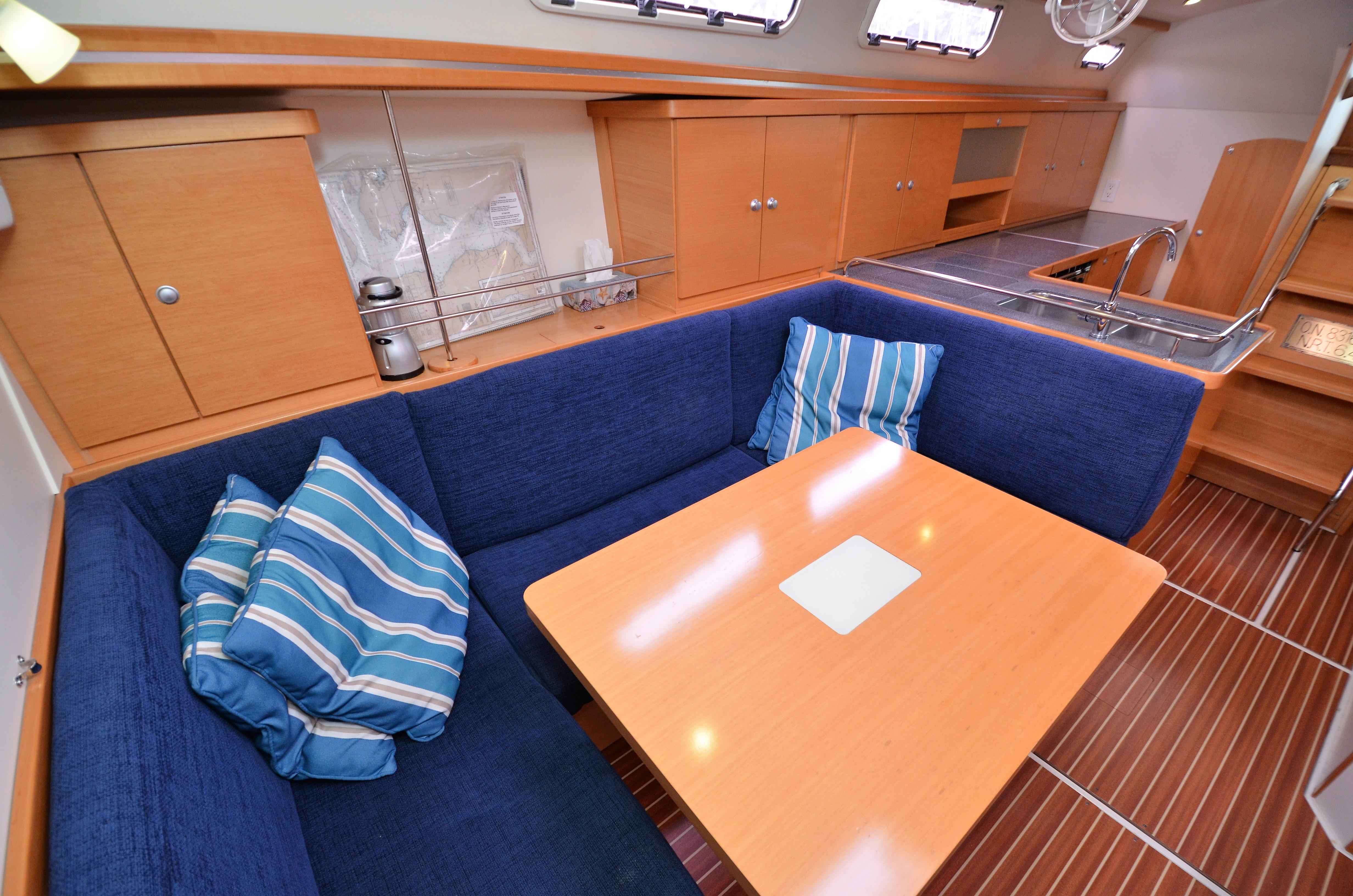 Interior of a 2007 Hanse 370e yacht with blue upholstery.