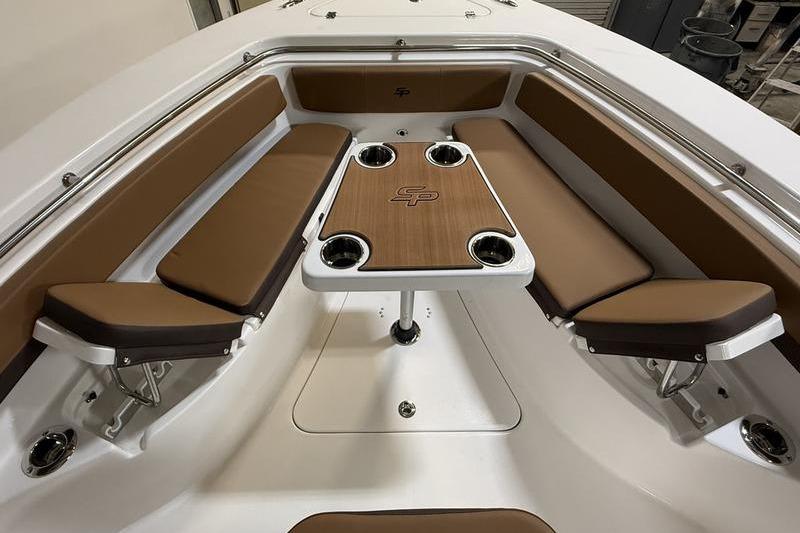2026 Sea Pro 242 Center Console boat interior with brown seating and table.