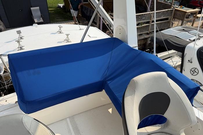 2007 Island Pilot 395 boat with blue seating and white helm chair on deck.