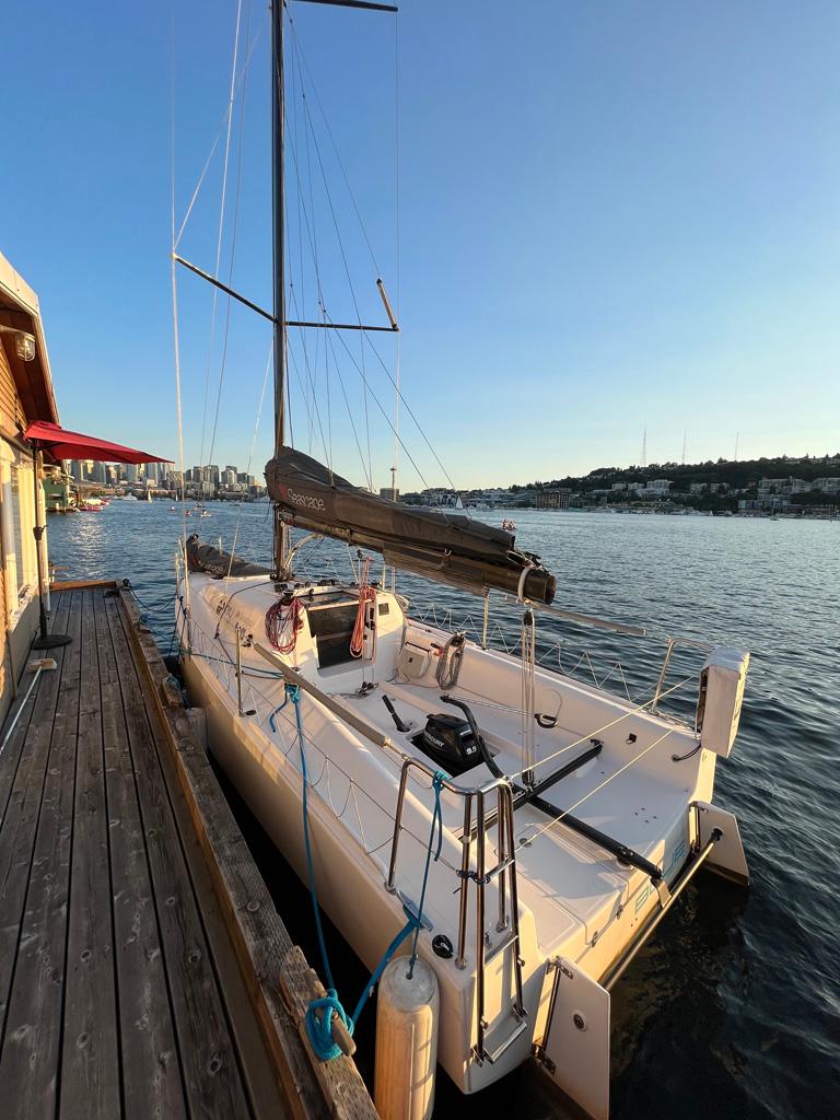 Sailboat Seascape 27 docked by a wooden pier at sunset, 2018 model.