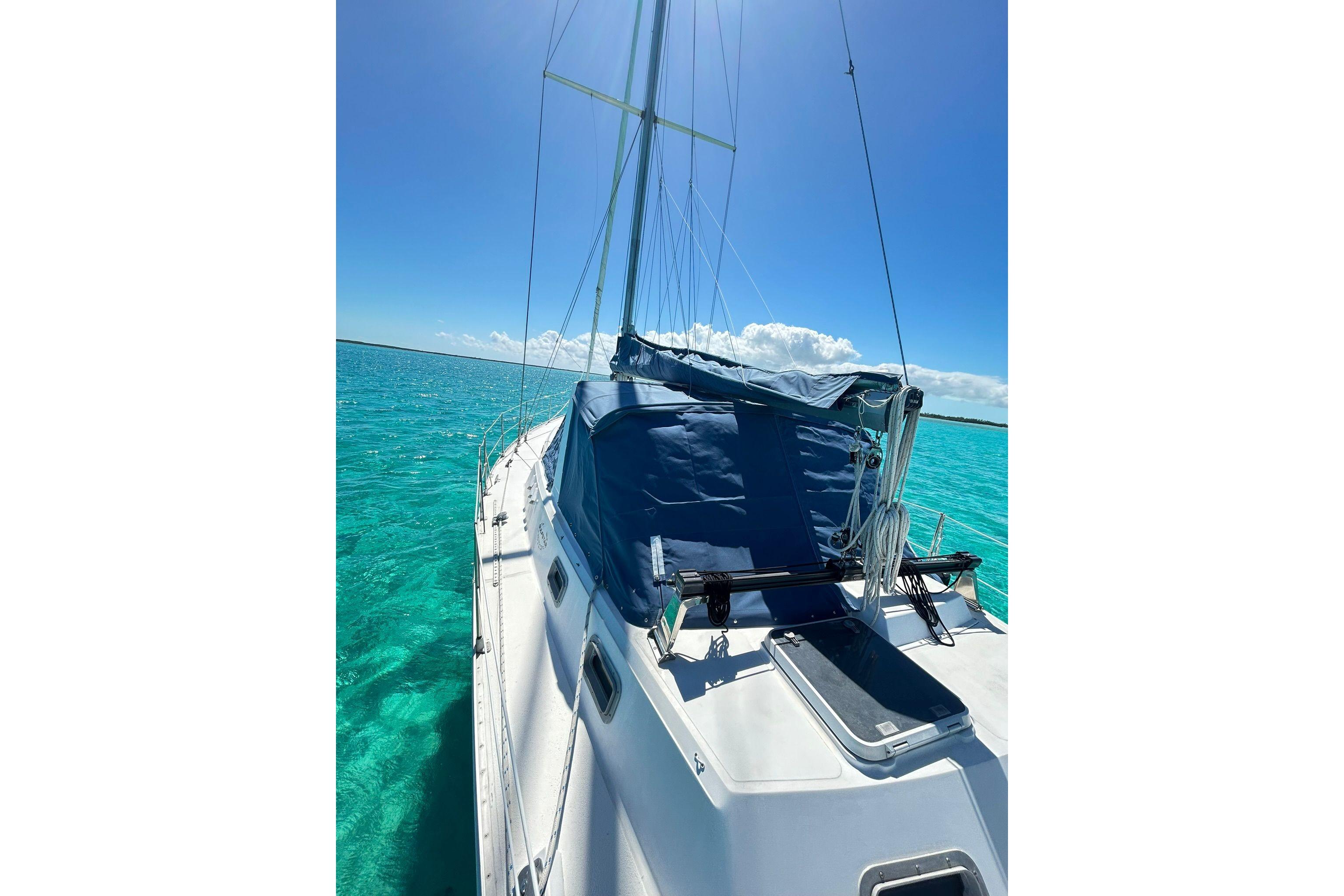 1987 Gulfstar CSY 50 Pilot House sailboat on clear turquoise water under blue sky.