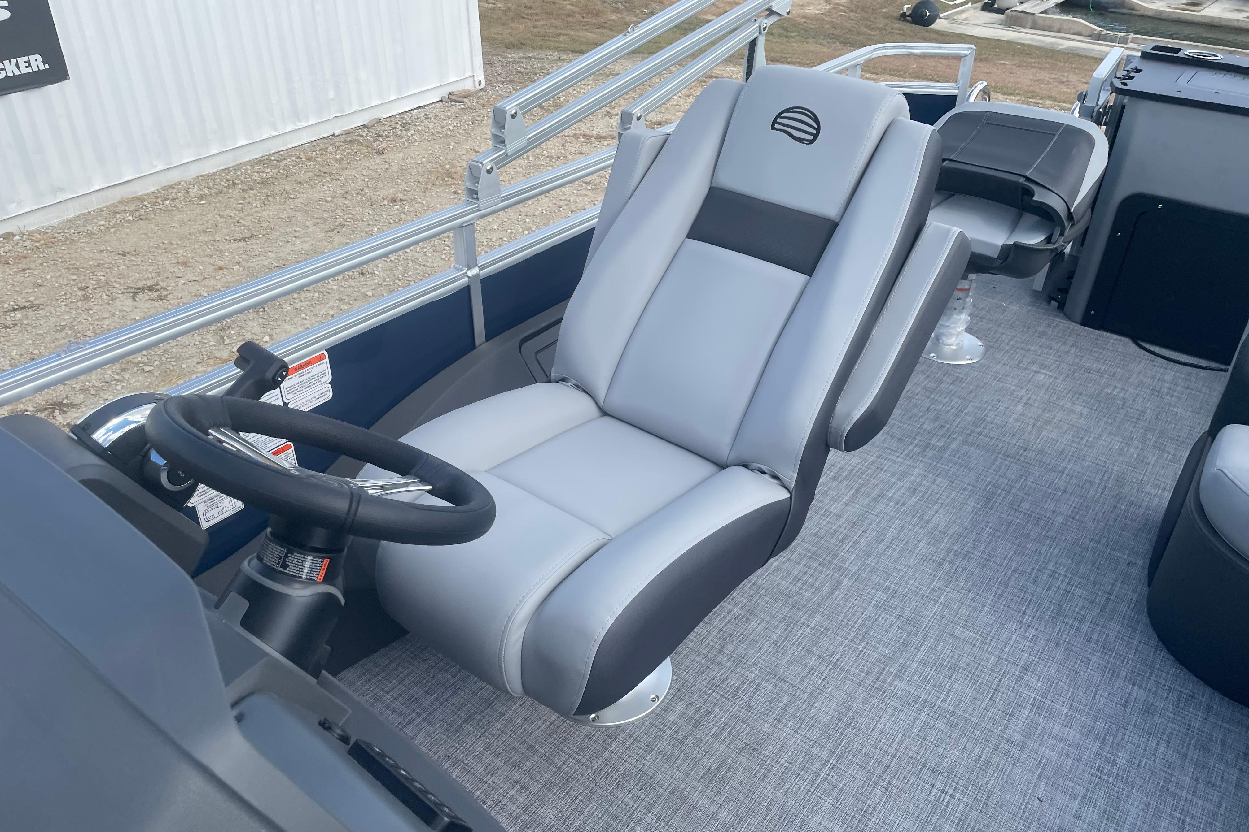 2026 Sun Tracker SportFish 22 DLX boat interior with steering wheel and comfortable seating.