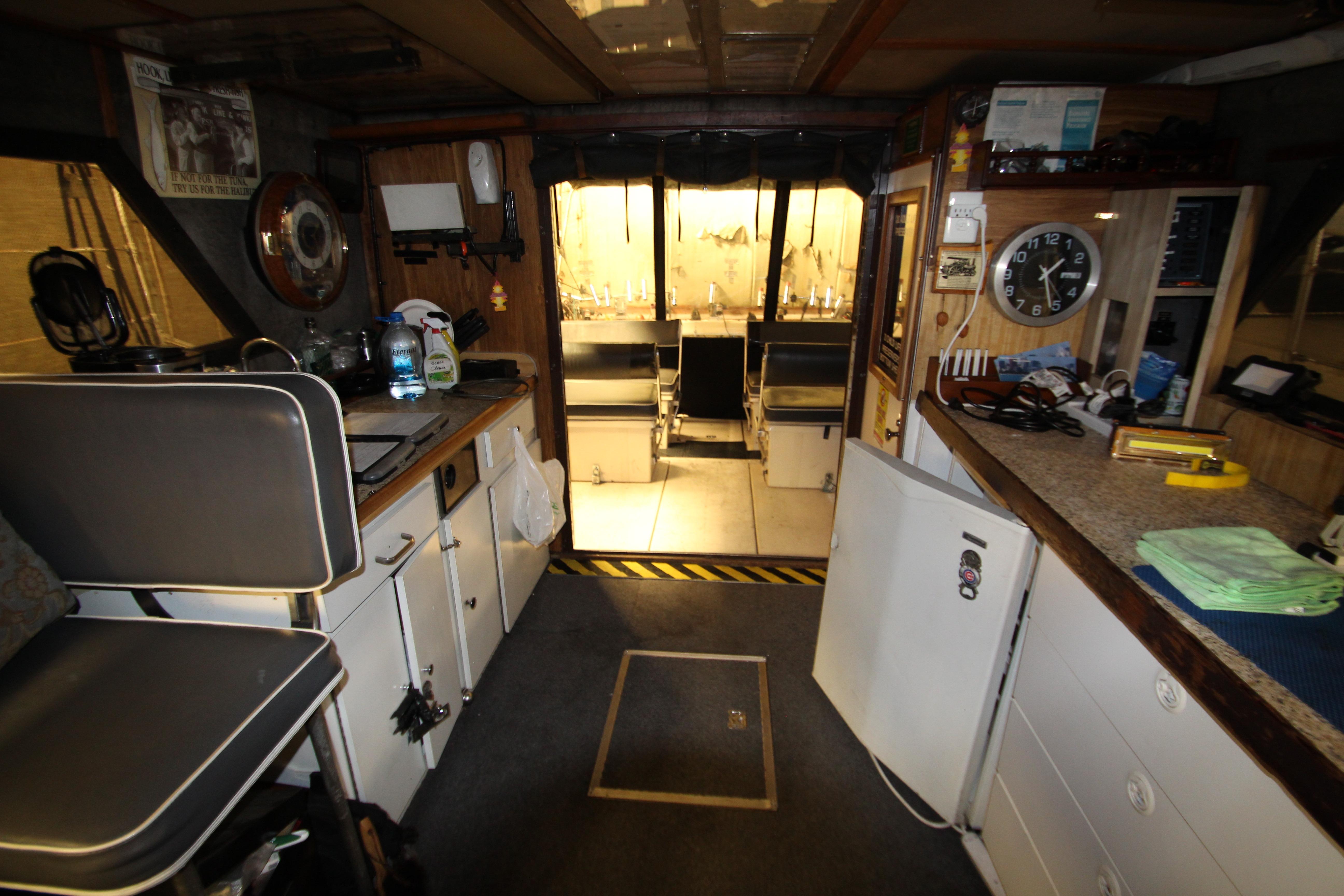 Interior of 1980 Delta Boatworks 34 Offshore, featuring kitchen and seating area.