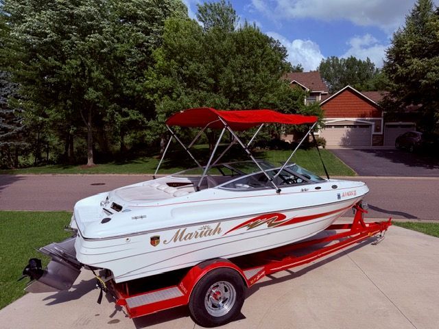 2001 Mariah Shabah with red trailer and canopy, parked in a residential area.