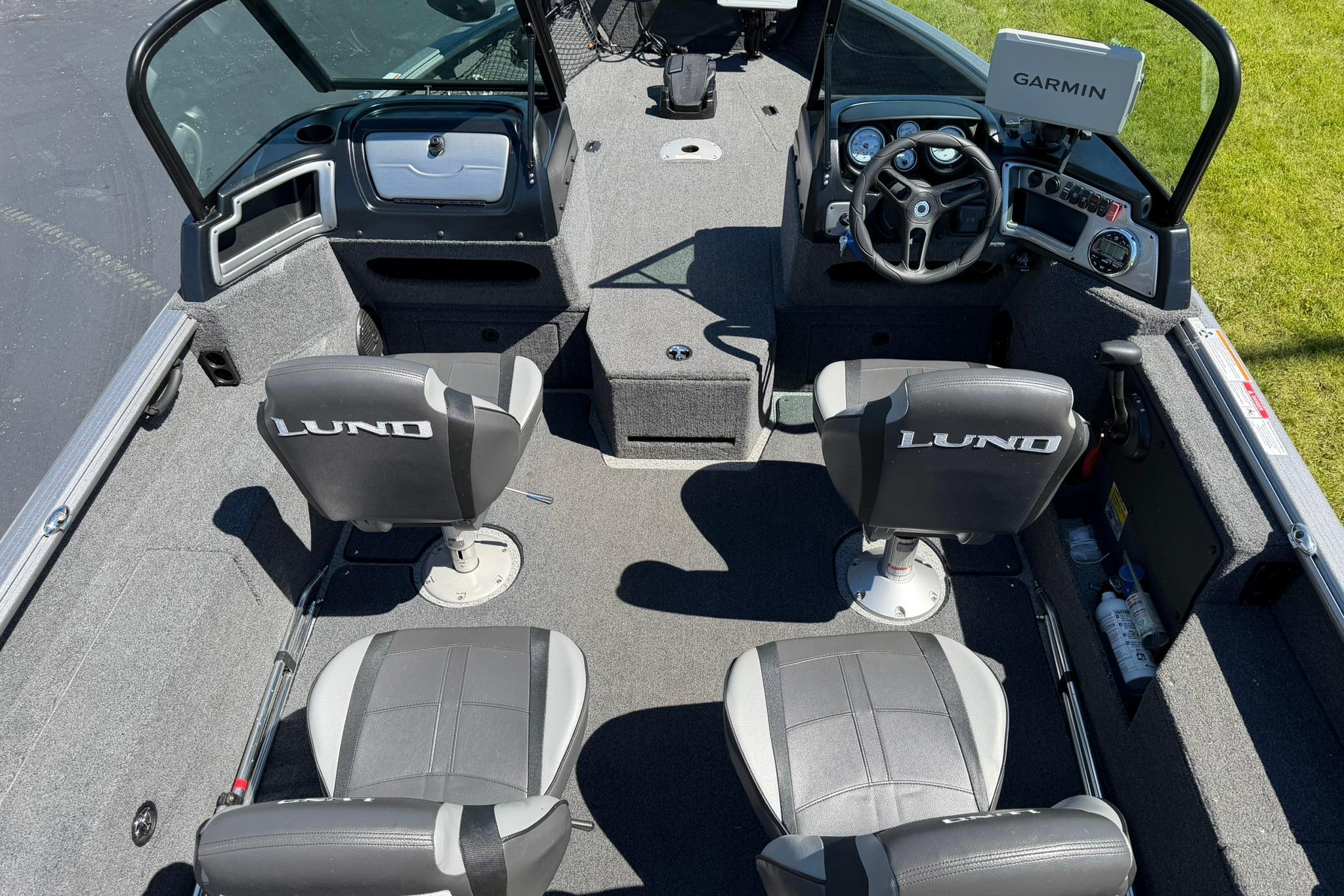 2024 Lund 1875 Impact XS Sport boat interior with Garmin navigation system and branded seating.