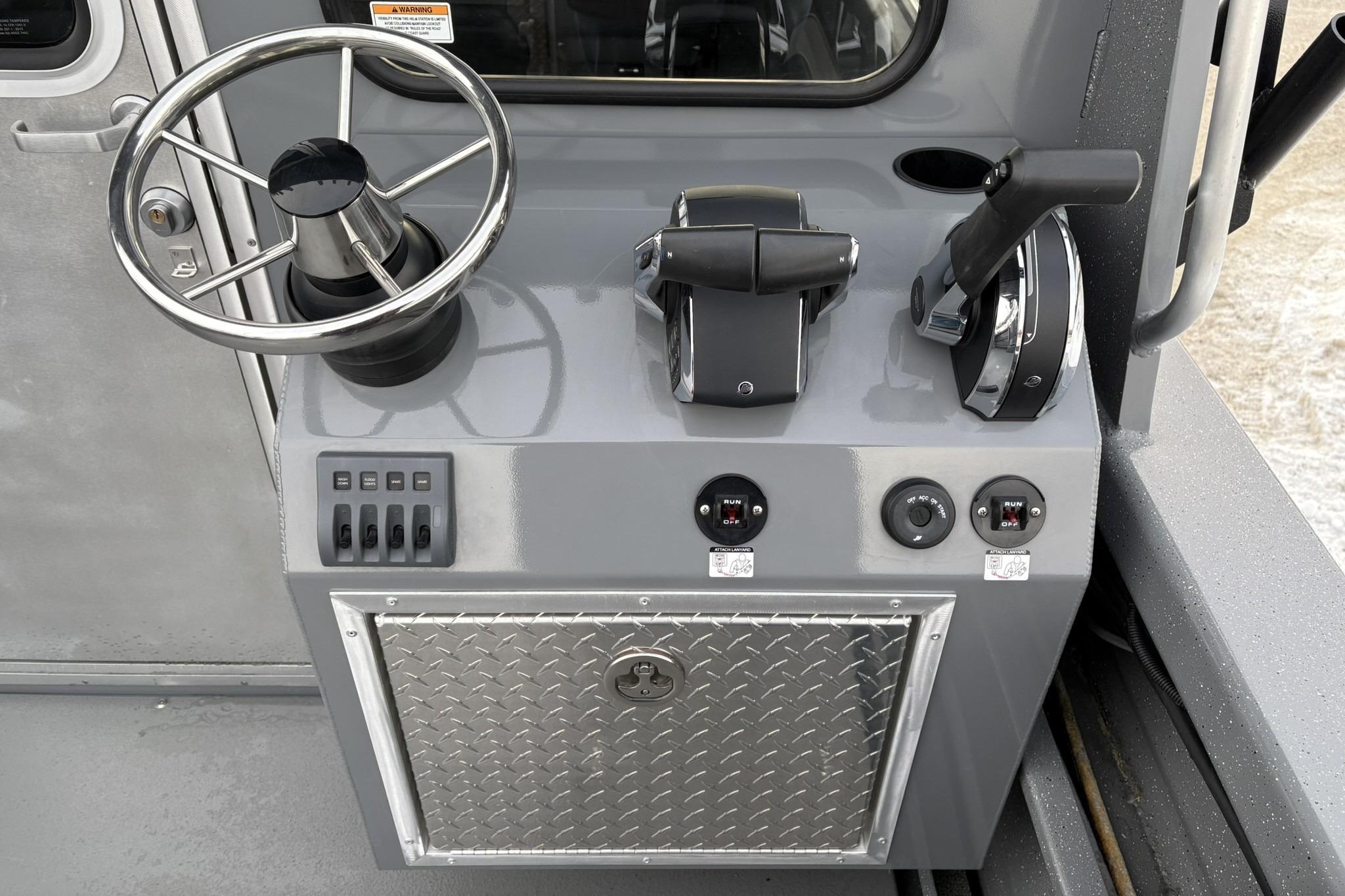 2024 Spartan 26 Maximus Pro XL boat console with steering wheel and controls.