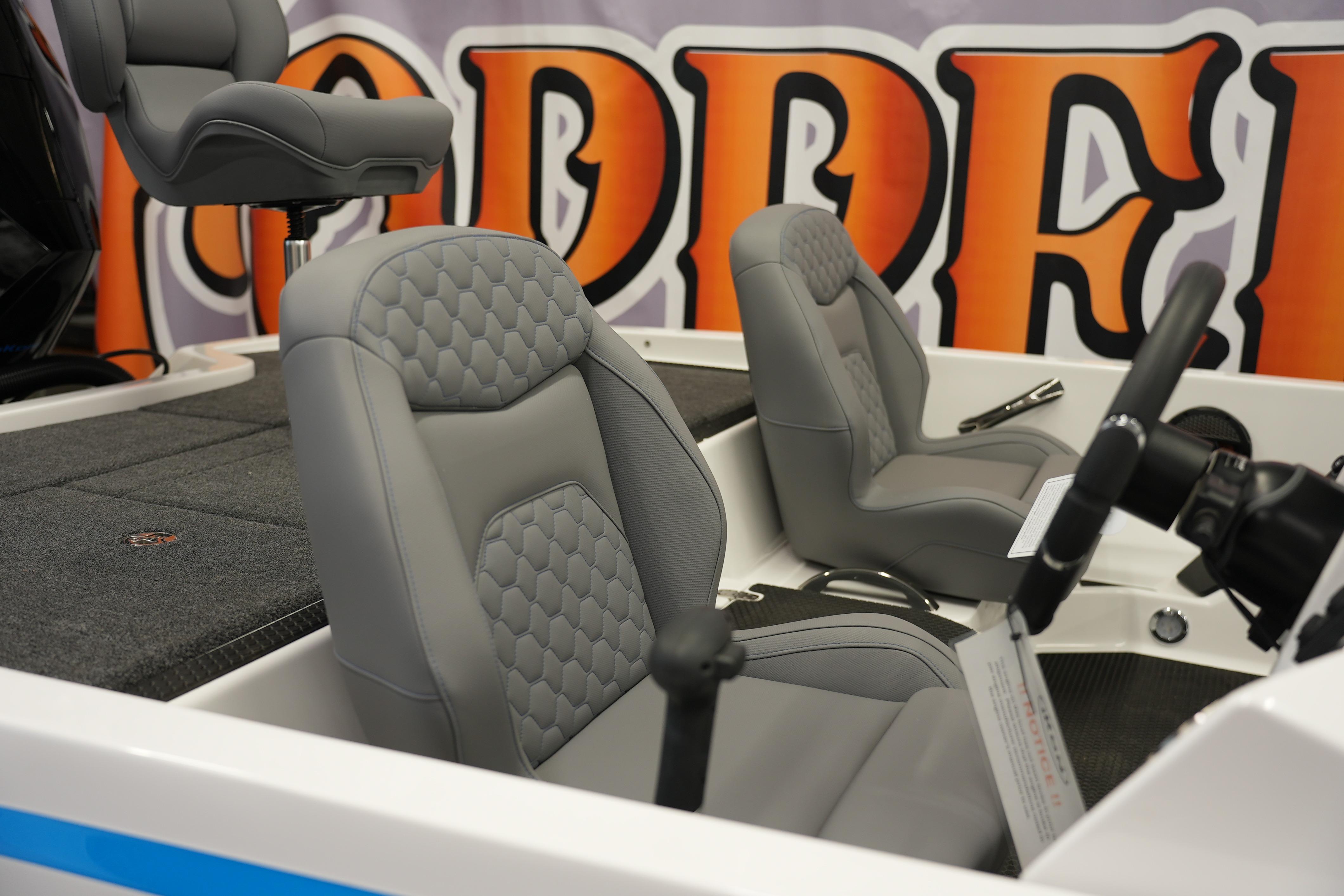 Gray seats in a 2026 iKon VLE21 boat interior with vibrant backdrop.