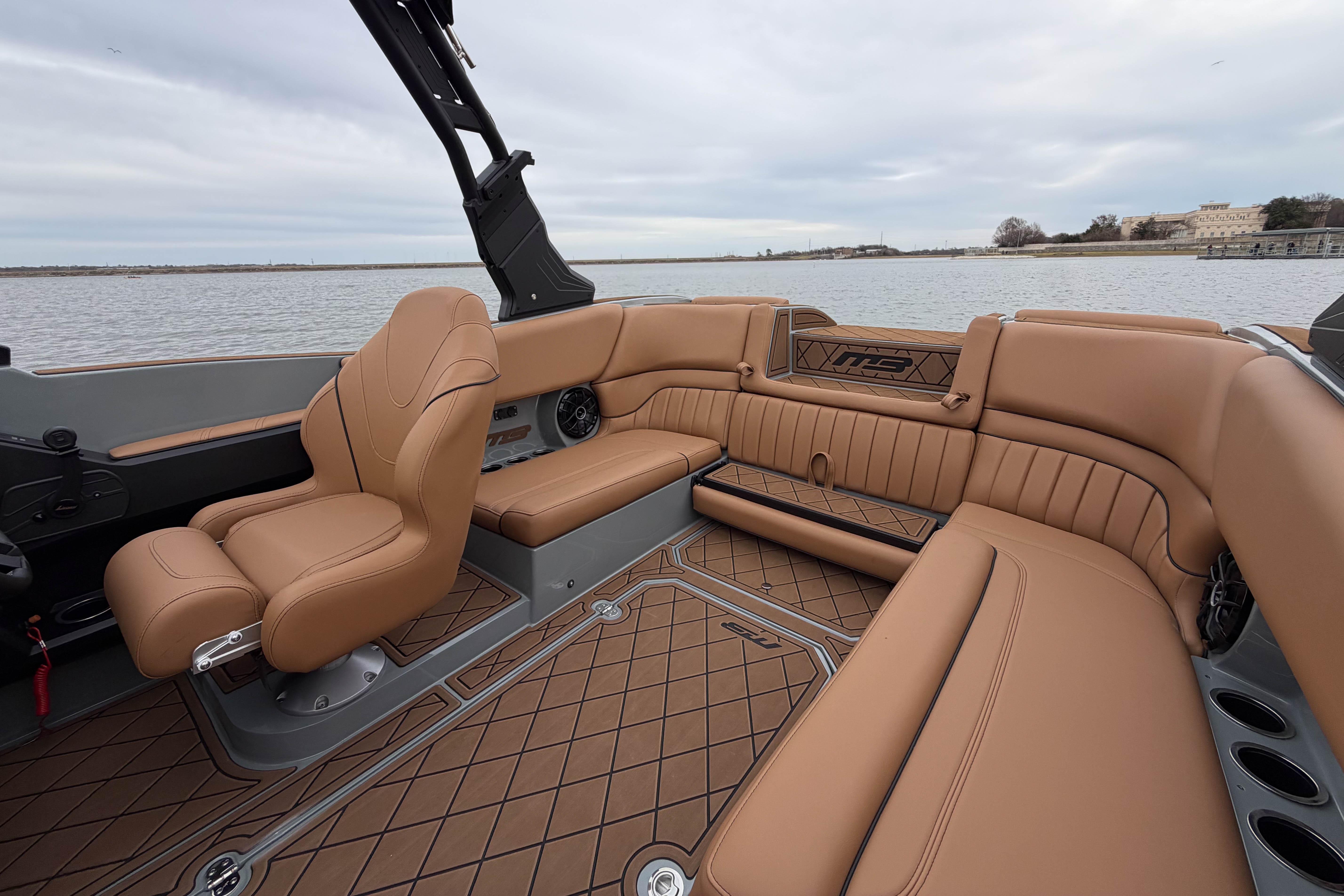 Luxurious interior of 2026 MB B52 21 Alpha boat with tan leather seating.