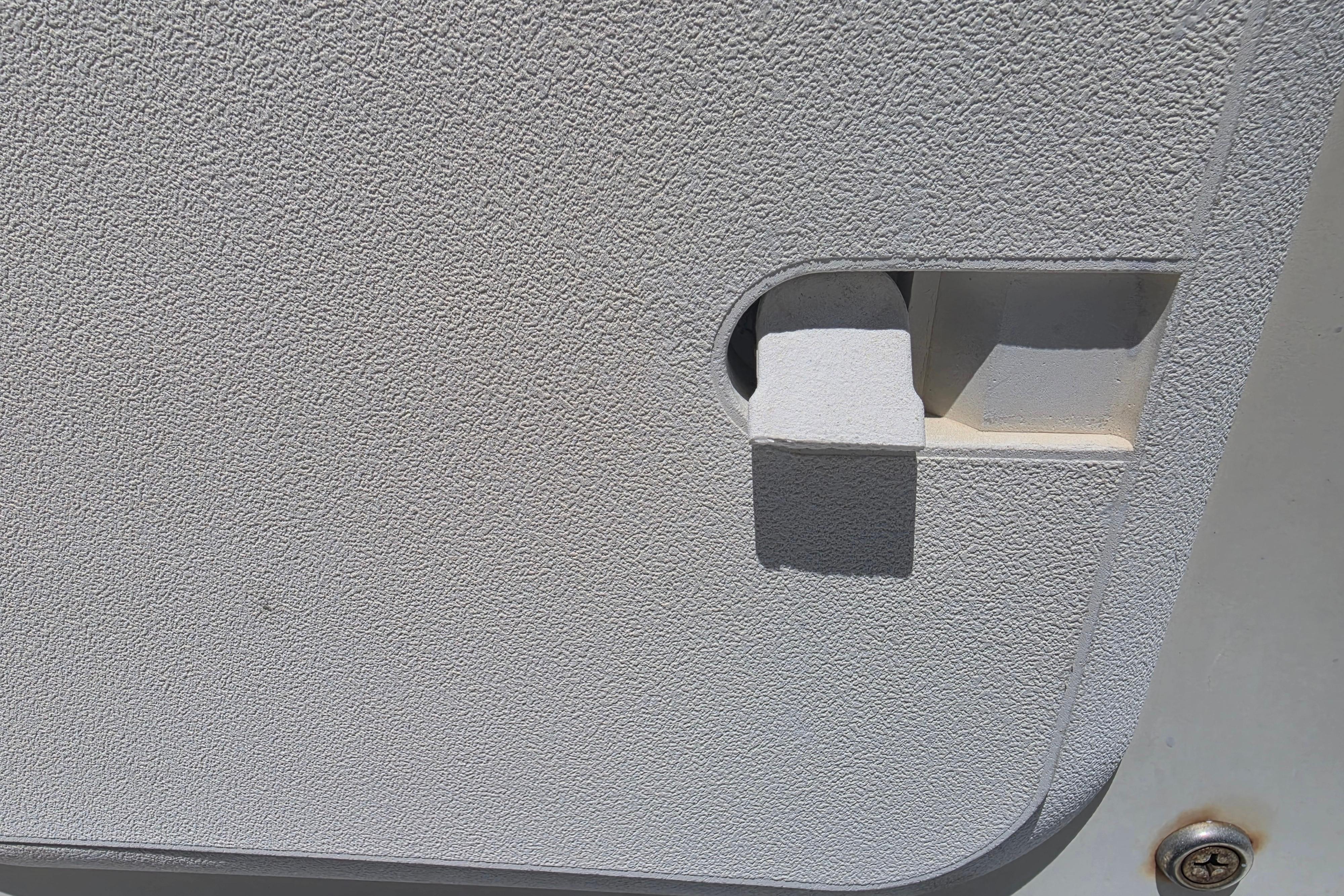 Textured panel with latch on a 2014 Custom Exuma Catamaran 32.