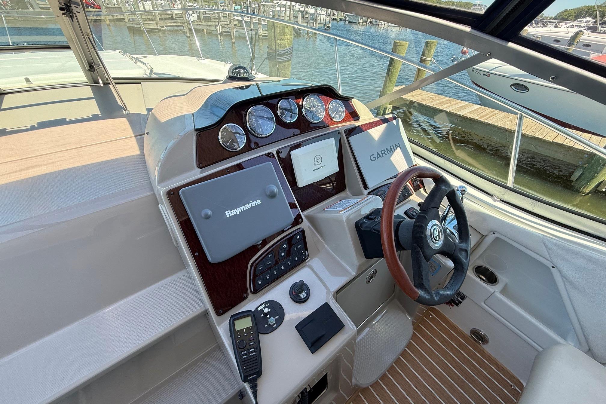 2008 Sea Ray Sundancer 330 helm with Raymarine and Garmin navigation systems.