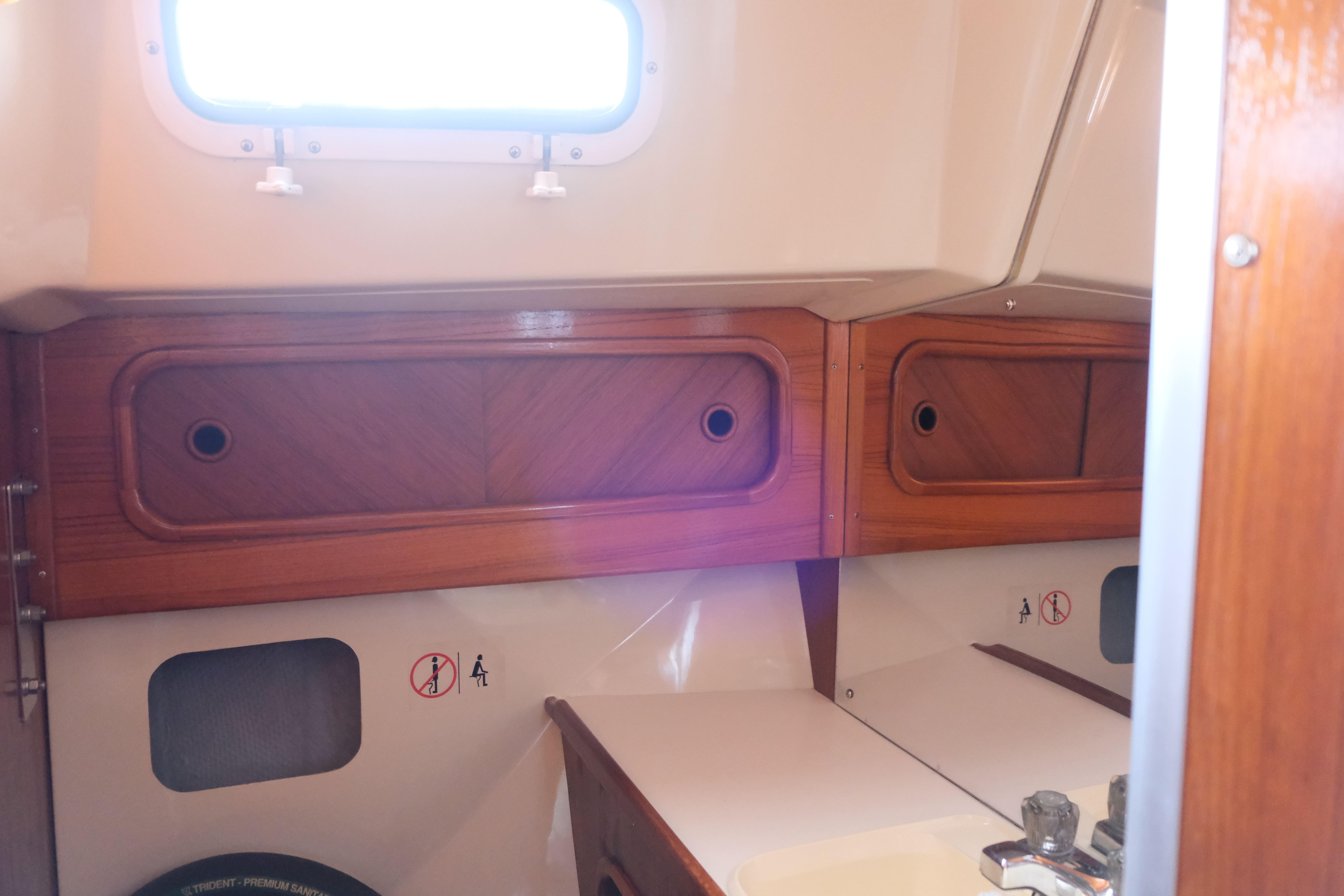 1988 Mirage Yachts 35 interior with wooden cabinets and nautical decor.