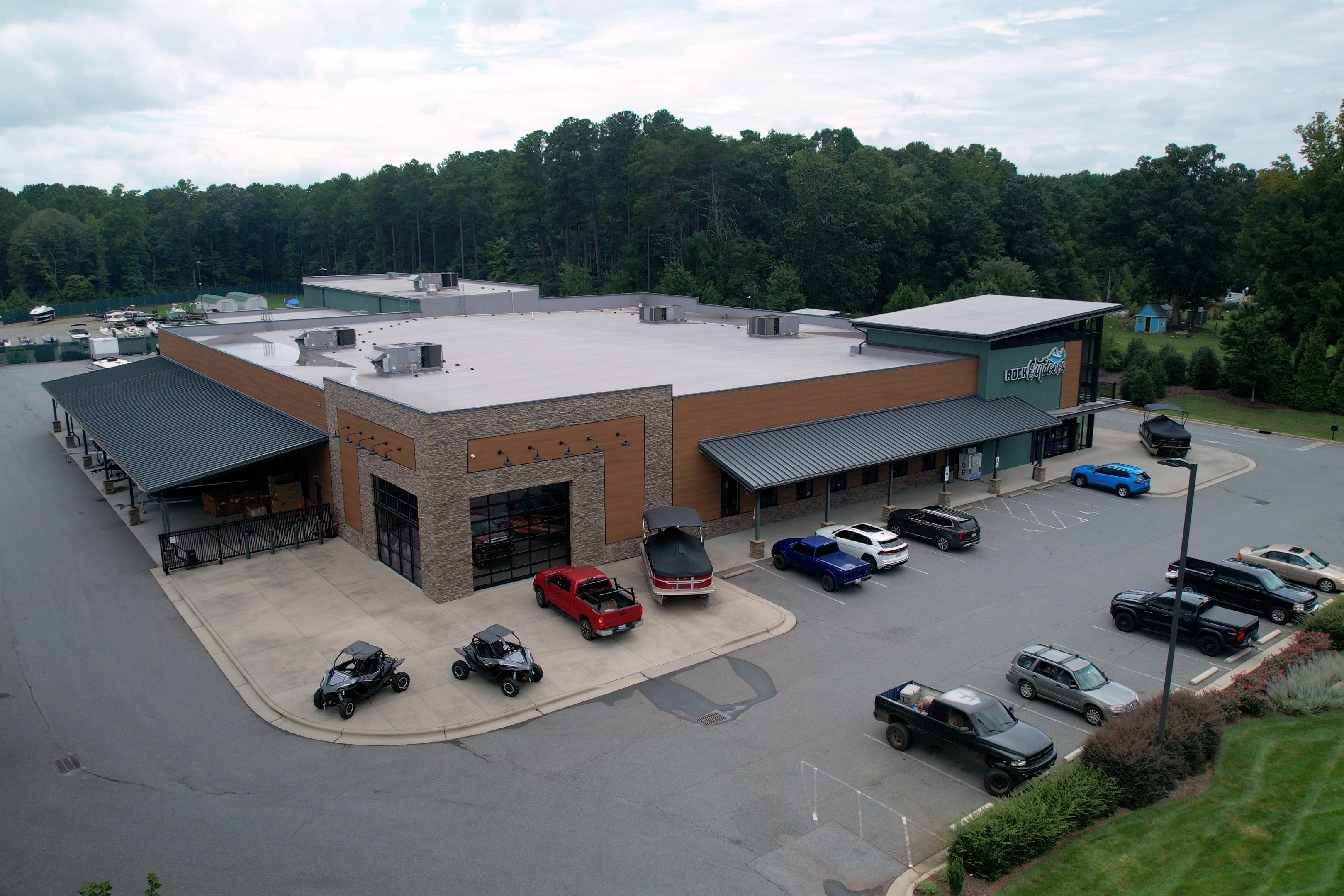 Aerial view of a commercial building with parked vehicles, including a G3 Gator Tough 17 SC boat.