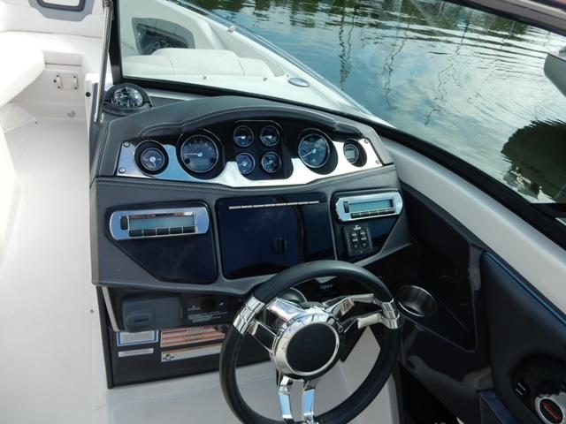 Dashboard of 2014 Monterey 288 Super Sport boat with steering wheel and gauges.