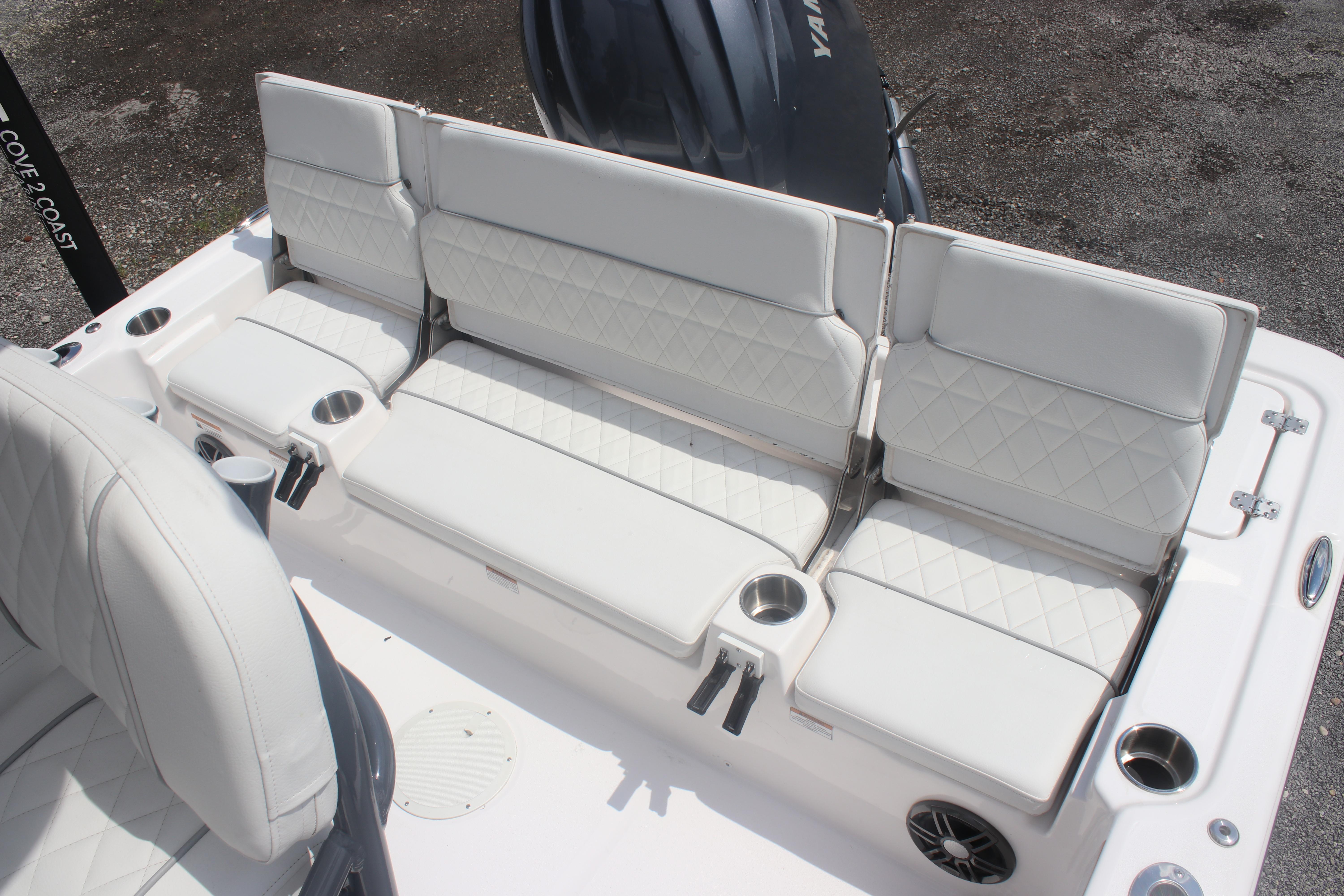 2025 Sea Fox 231 Bay Fox boat seating with white cushions and cup holders.