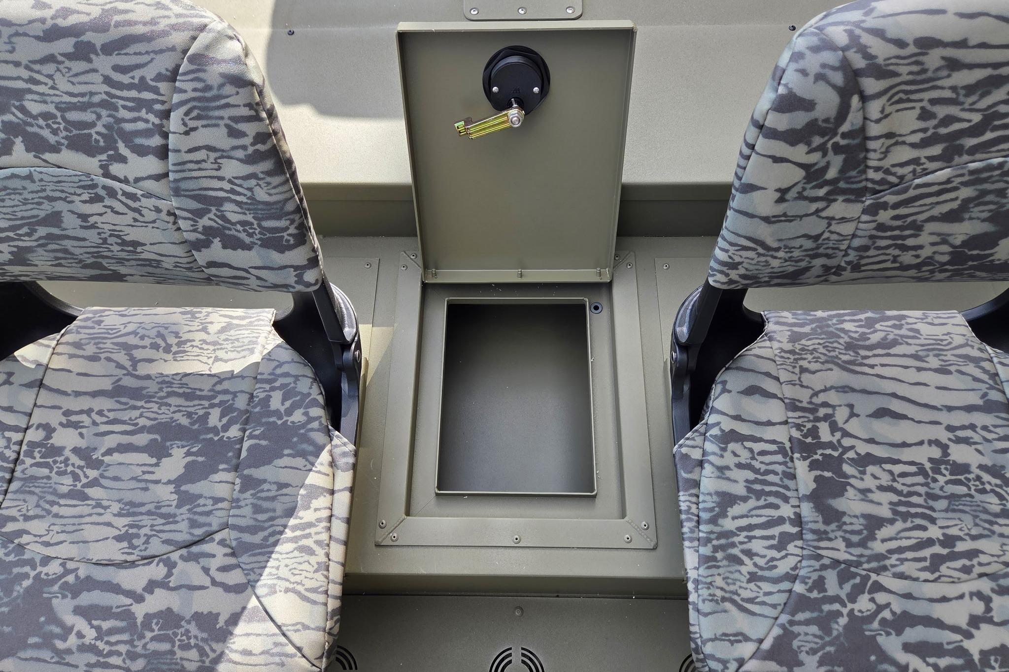 2026 Tracker Grizzly 1754 SC boat interior with camo seats and storage compartment.