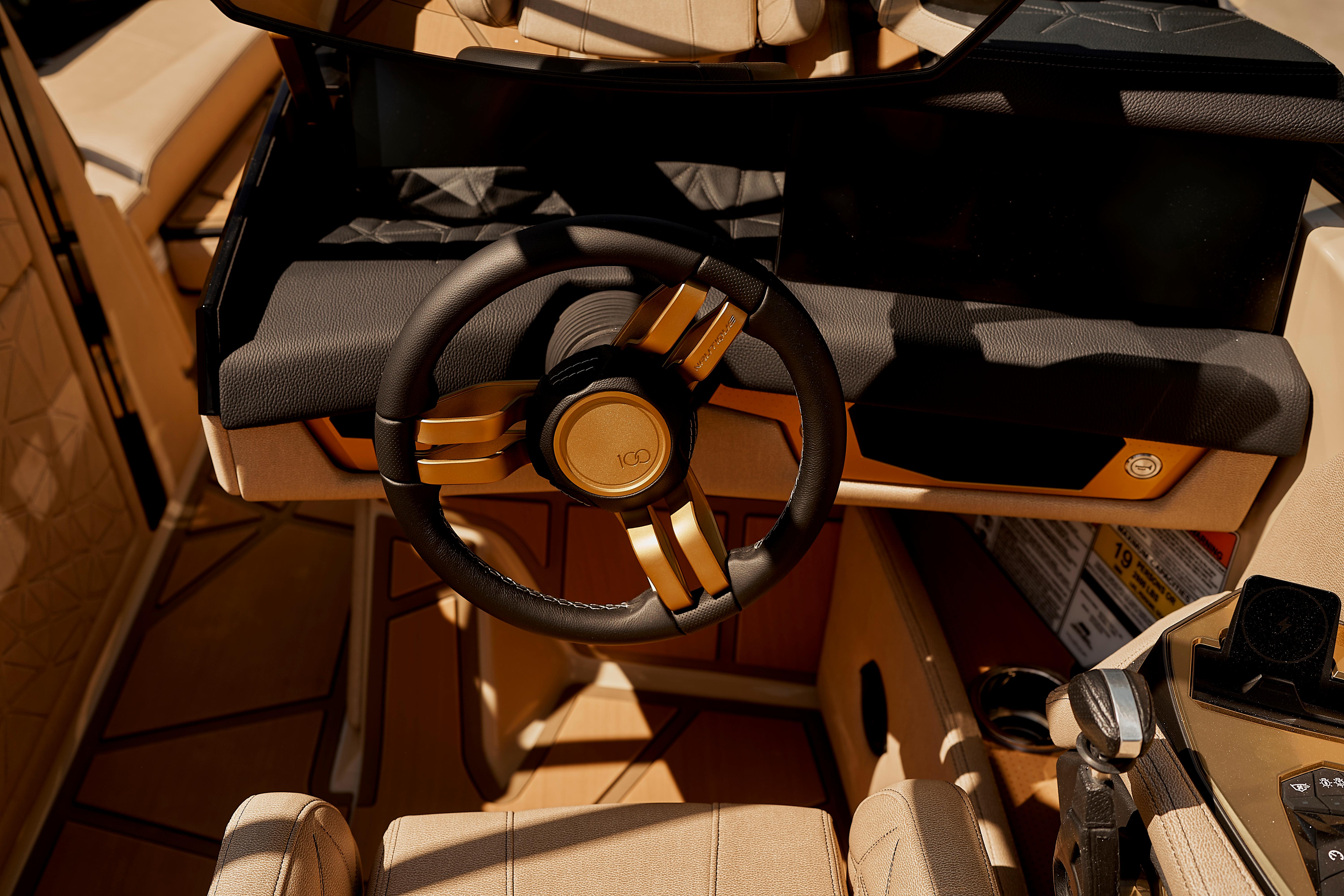 2025 Nautique Super Air Nautique G25 Paragon steering wheel and dashboard in luxury interior.