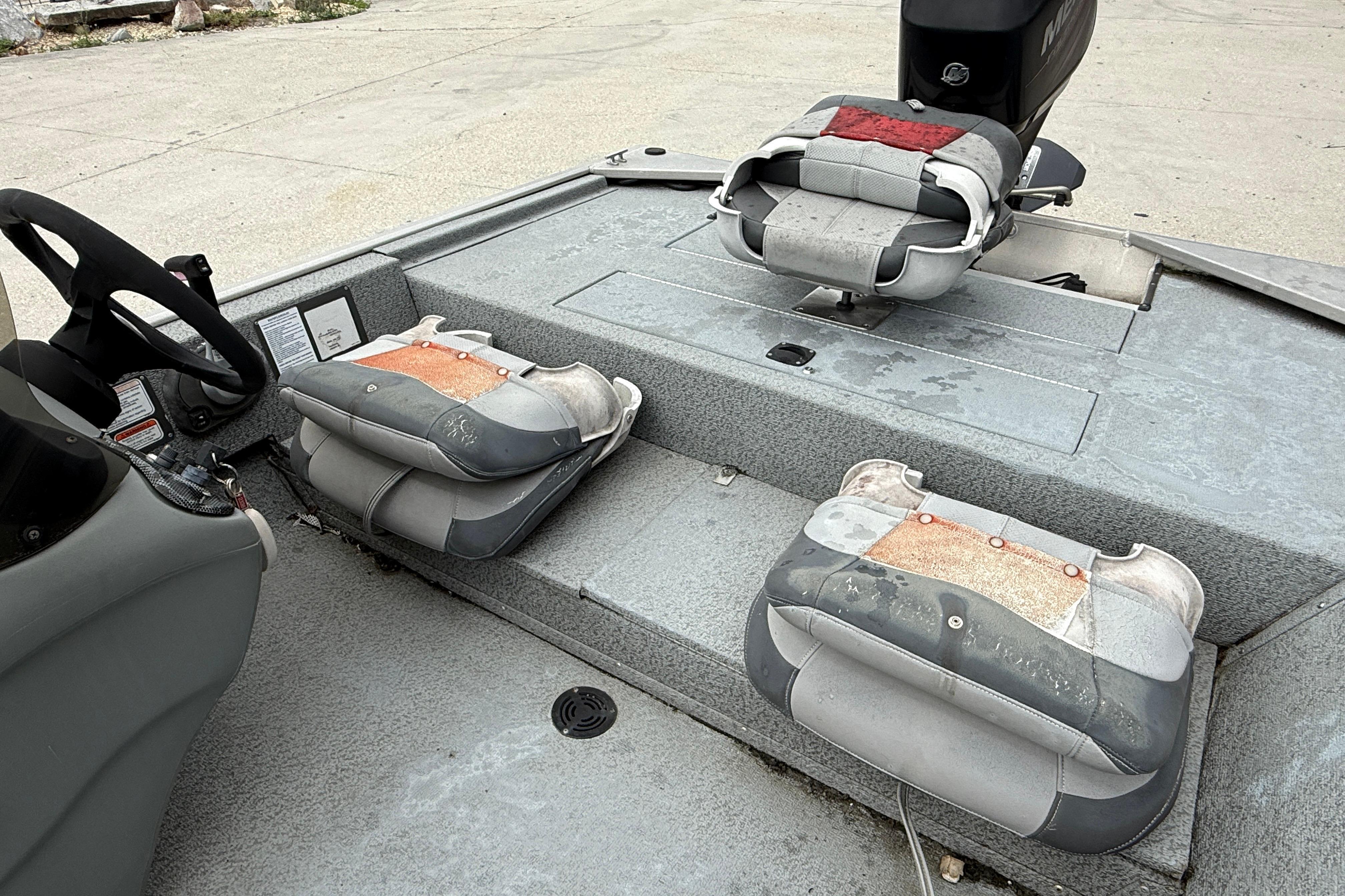 2016 Tracker Pro 170 boat interior with worn seats and steering wheel.