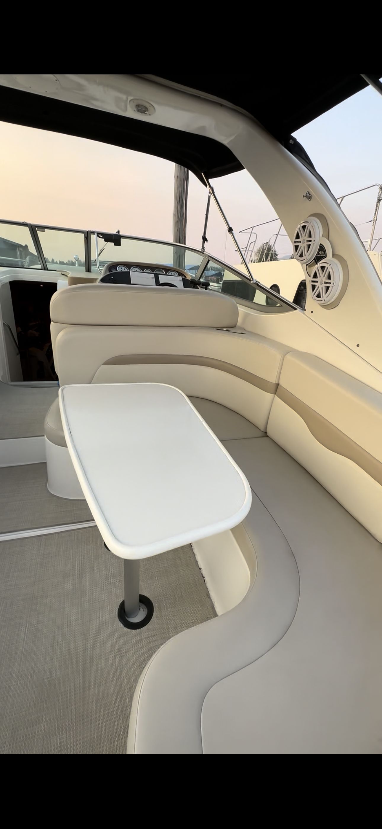 The image shows the interior of a 2004 Chaparral Signature 330 boat with an elegant seating area.