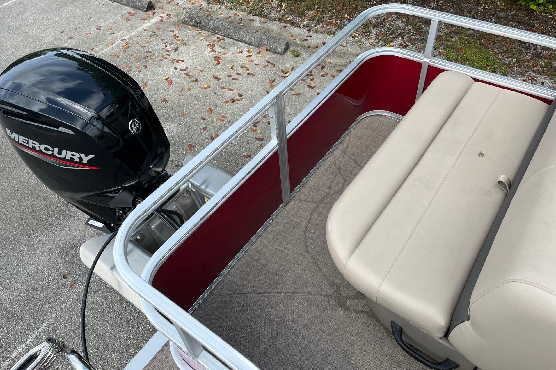 2025 Sun Tracker Party Barge 18 DLX with Mercury outboard motor and beige seating.
