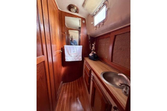 1982 Lancer 45 Motorsailer bathroom with wooden interior and sink.