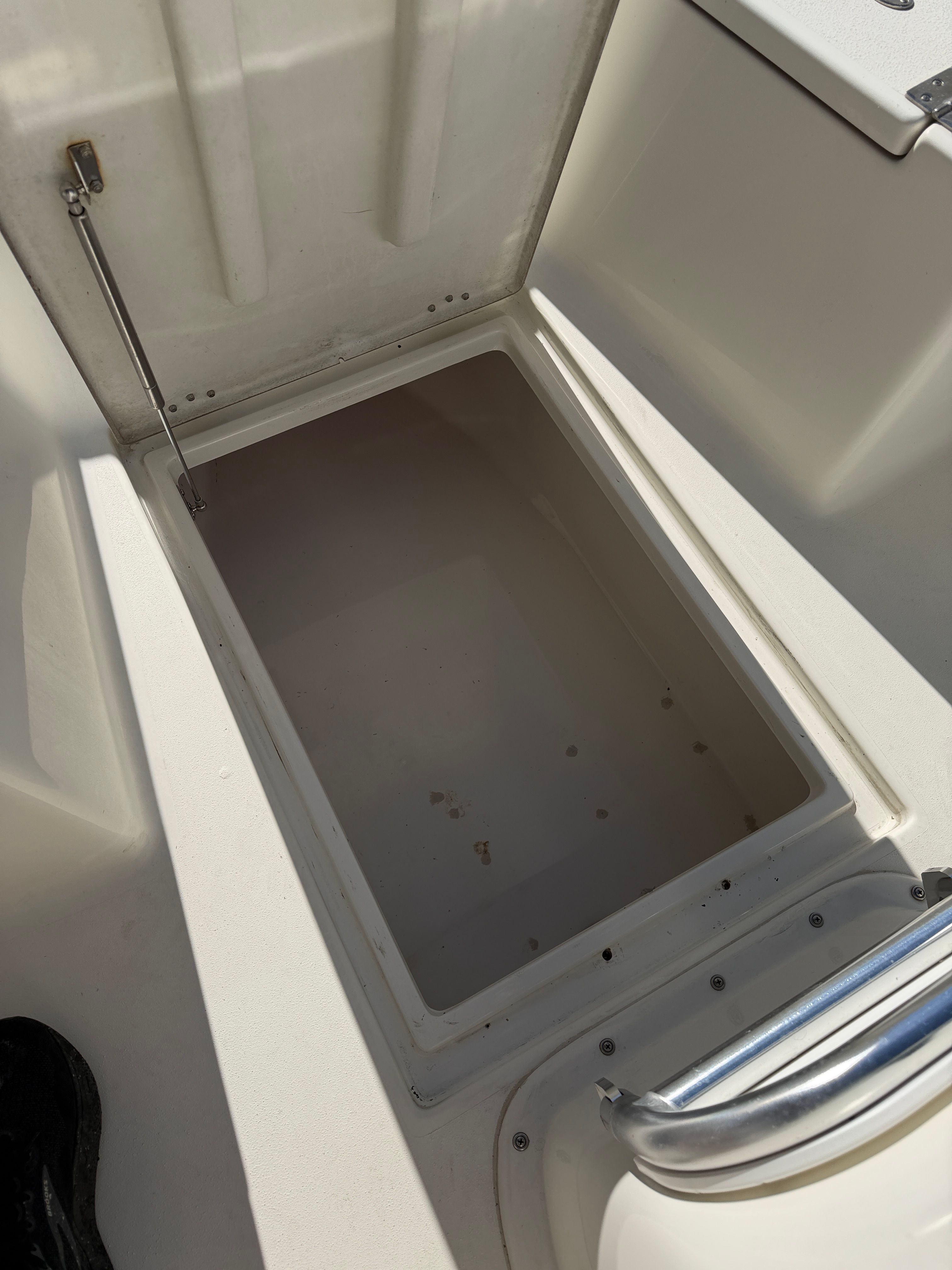 Open storage compartment on a 2021 KenCraft Challenger boat.