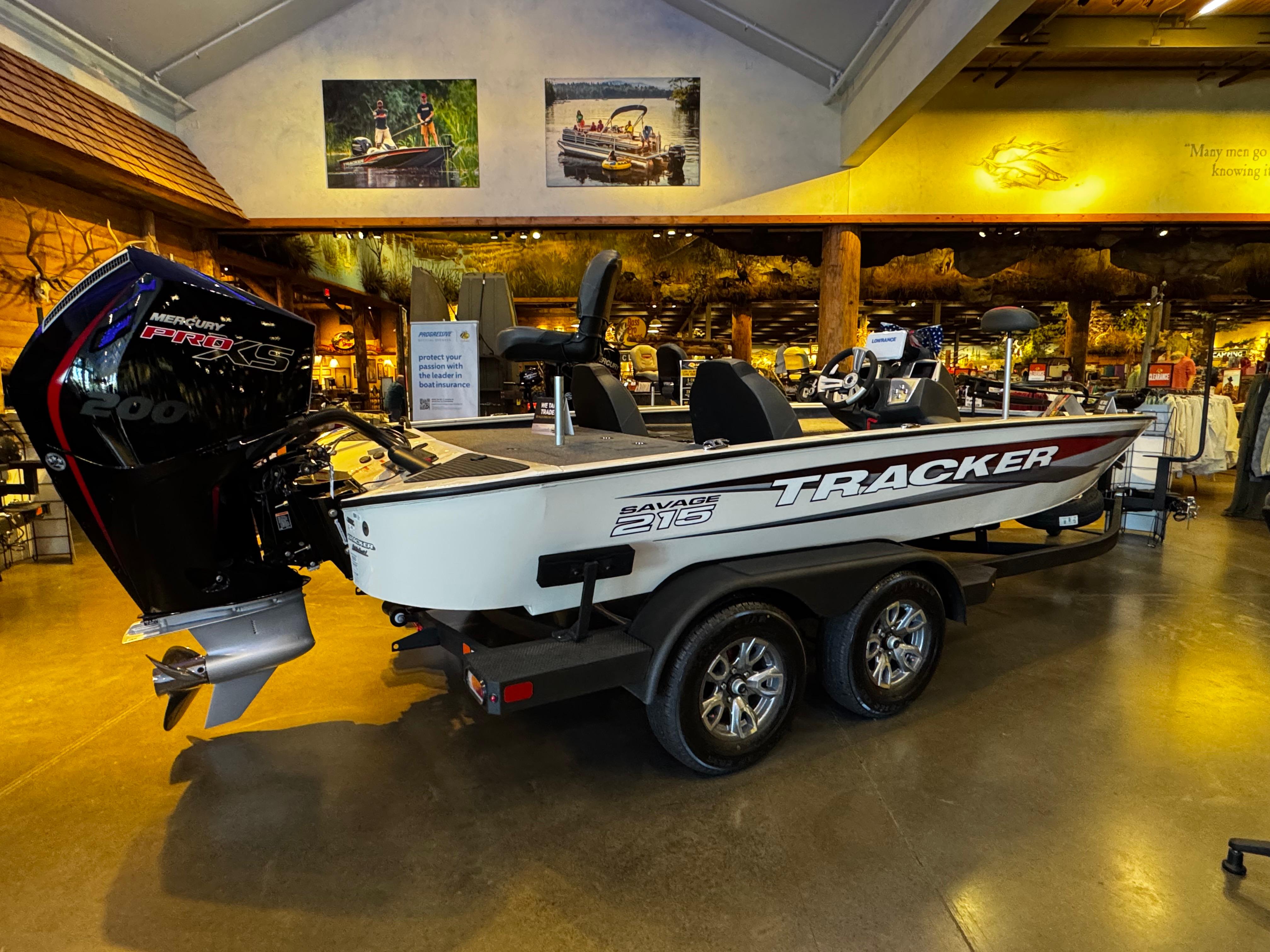 2025 Tracker Savage 215 boat displayed indoors with Mercury Pro XS engine.