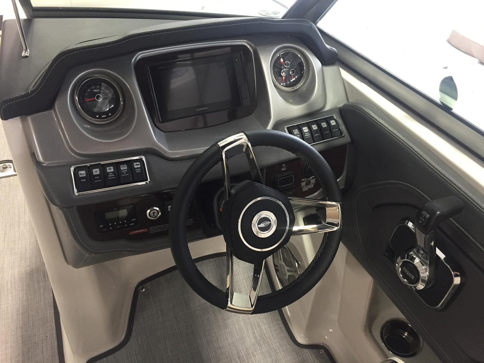2019 Chaparral 264 Sunesta helm with steering wheel and instruments.
