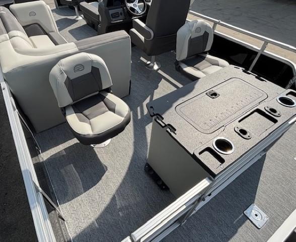 2026 Sun Tracker Fishin' Barge 20 DLX interior with seating and fishing station.