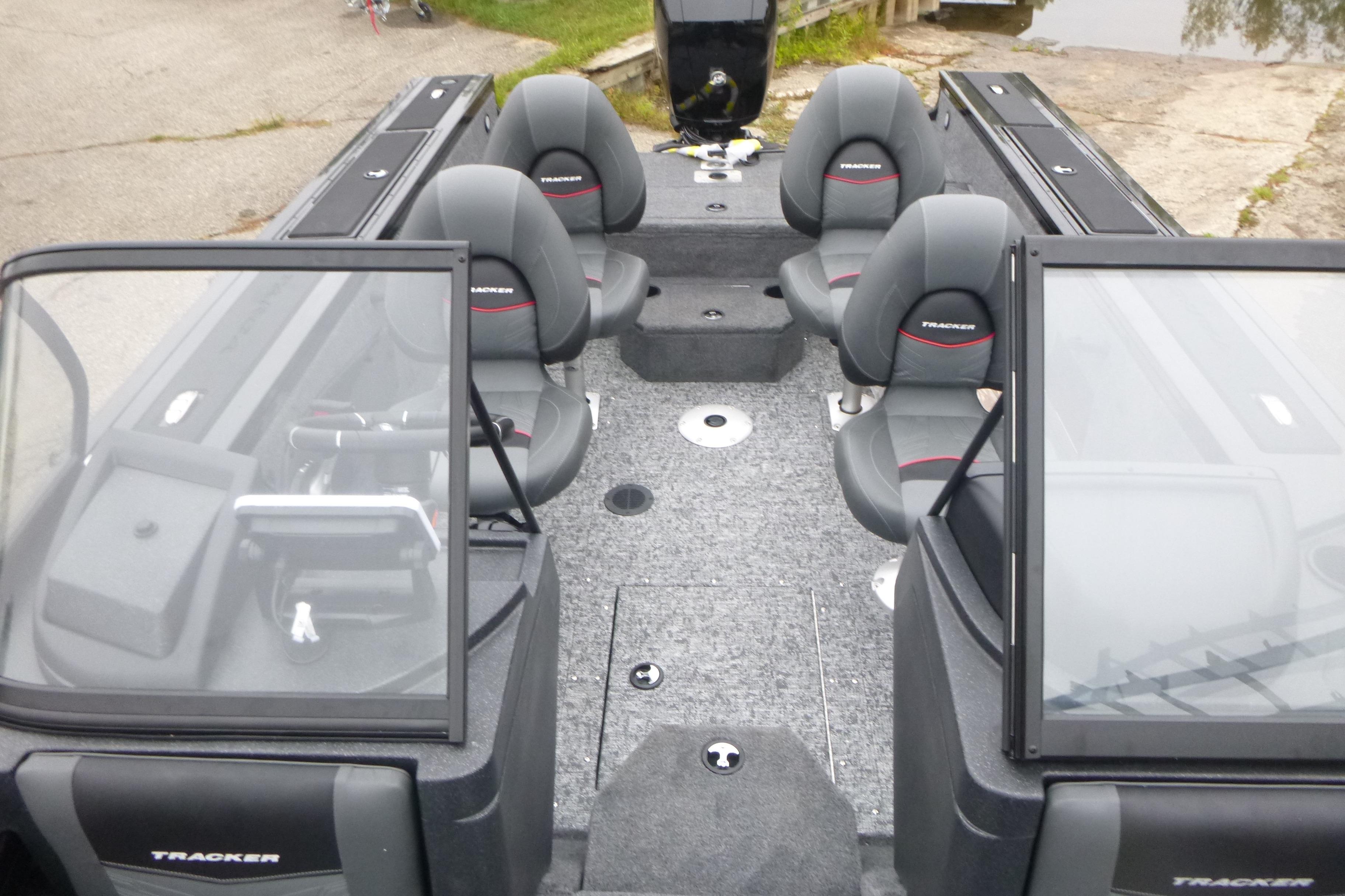 2026 Tracker Targa V-18 Combo boat interior with seating and windshield, docked near water.