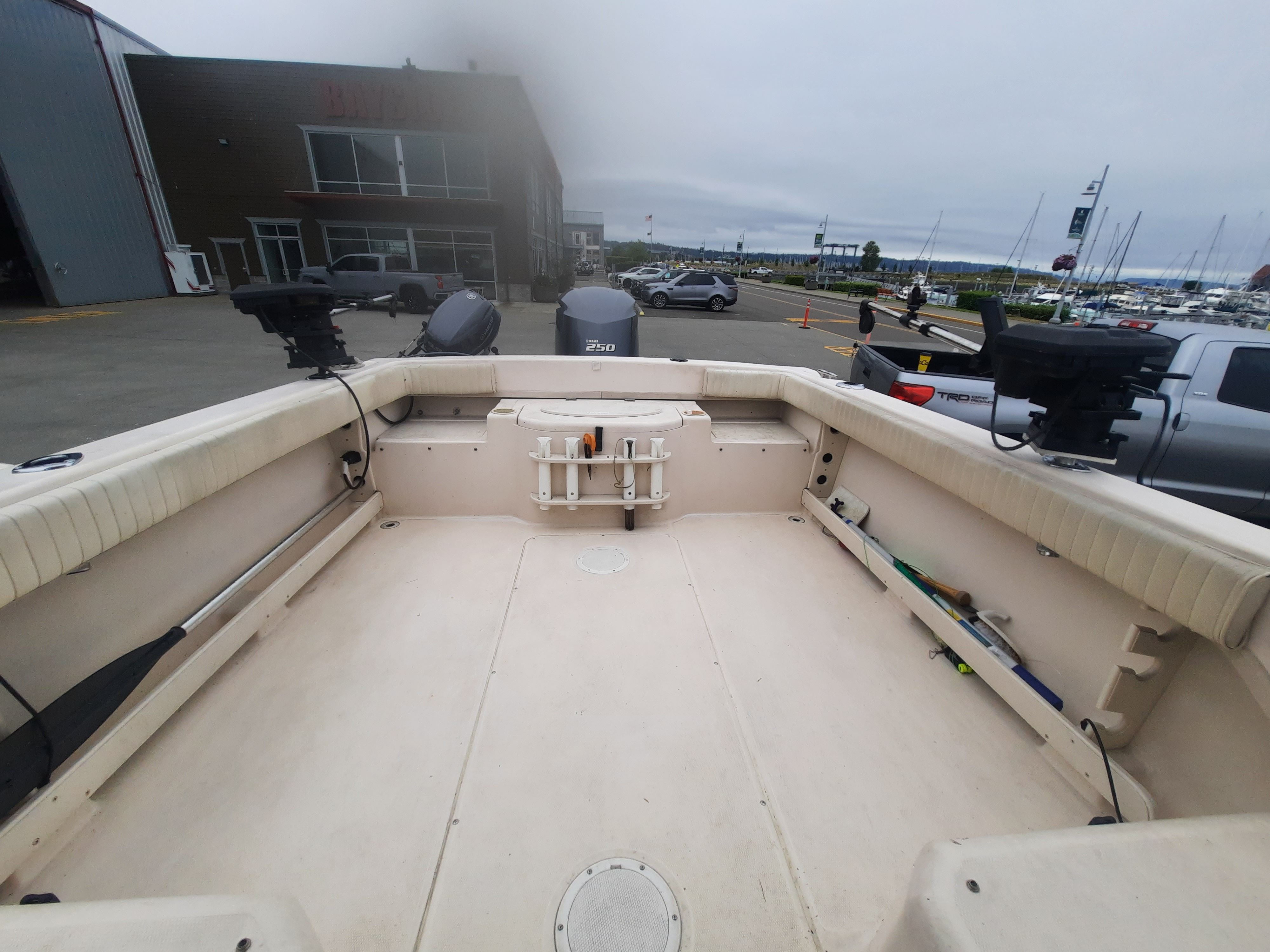 The image shows the open deck of a 2000 Grady-White Seafarer 228 boat, parked in a harbor area.