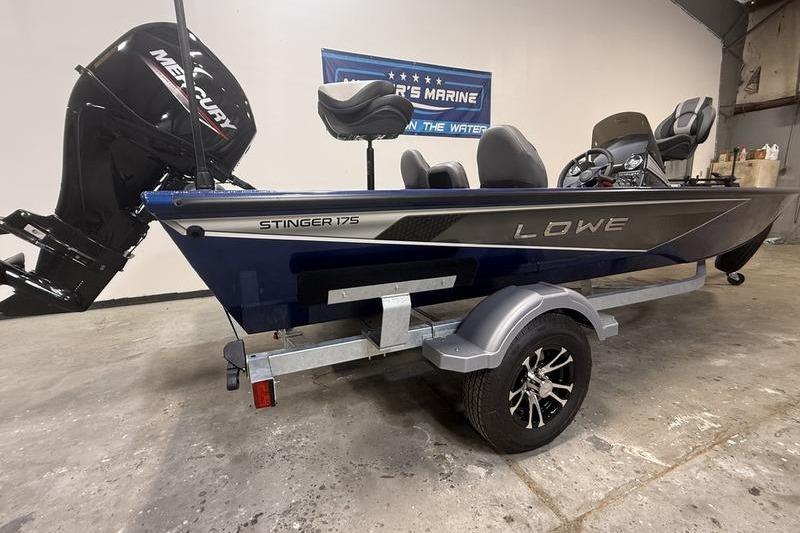 2026 Lowe Stinger 175C boat with Mercury engine on display in a showroom.