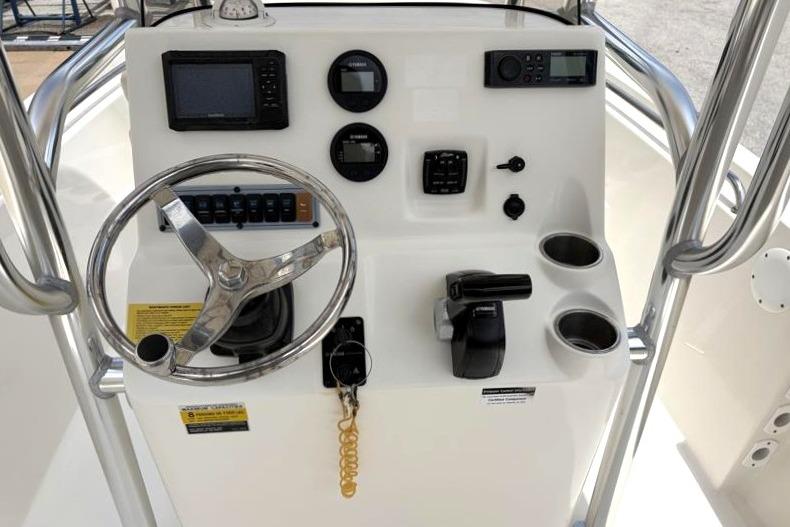 2023 Key West 203 FS boat console with steering wheel, gauges, and controls.