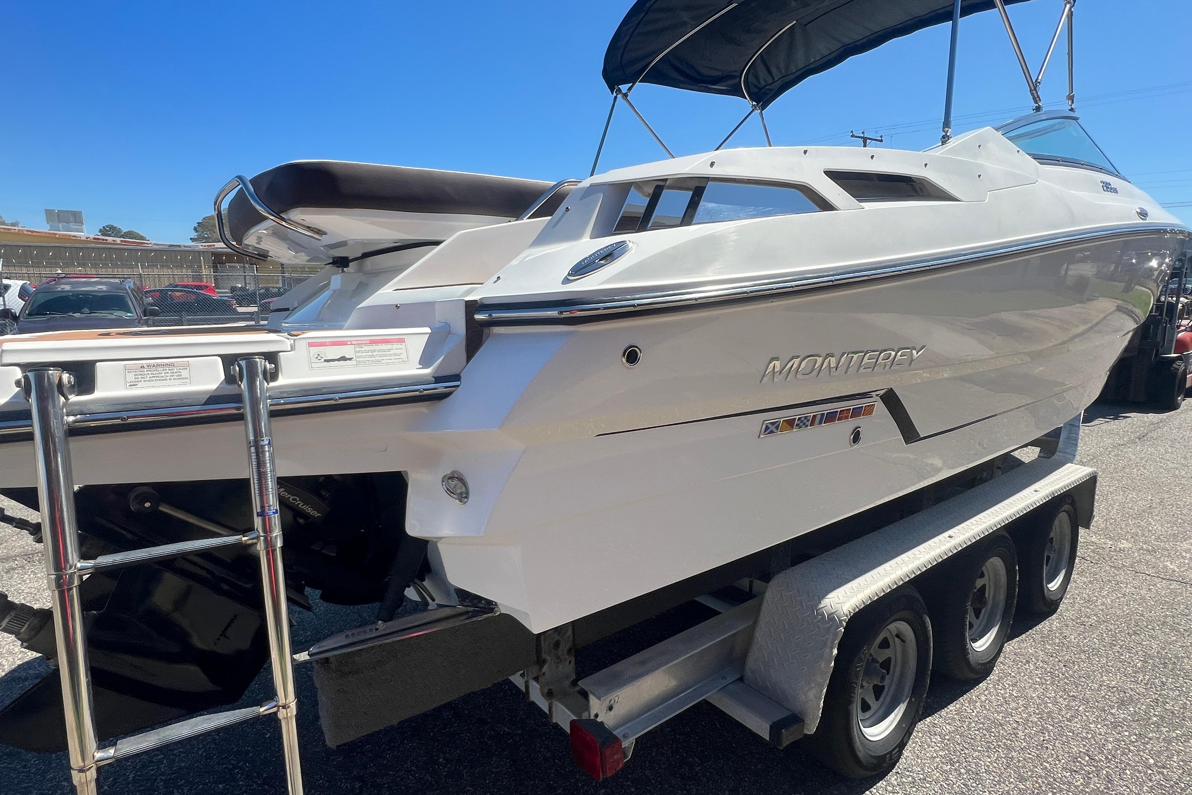 2017 Monterey 298SS Super Sport boat on trailer, sunny day, rear view.