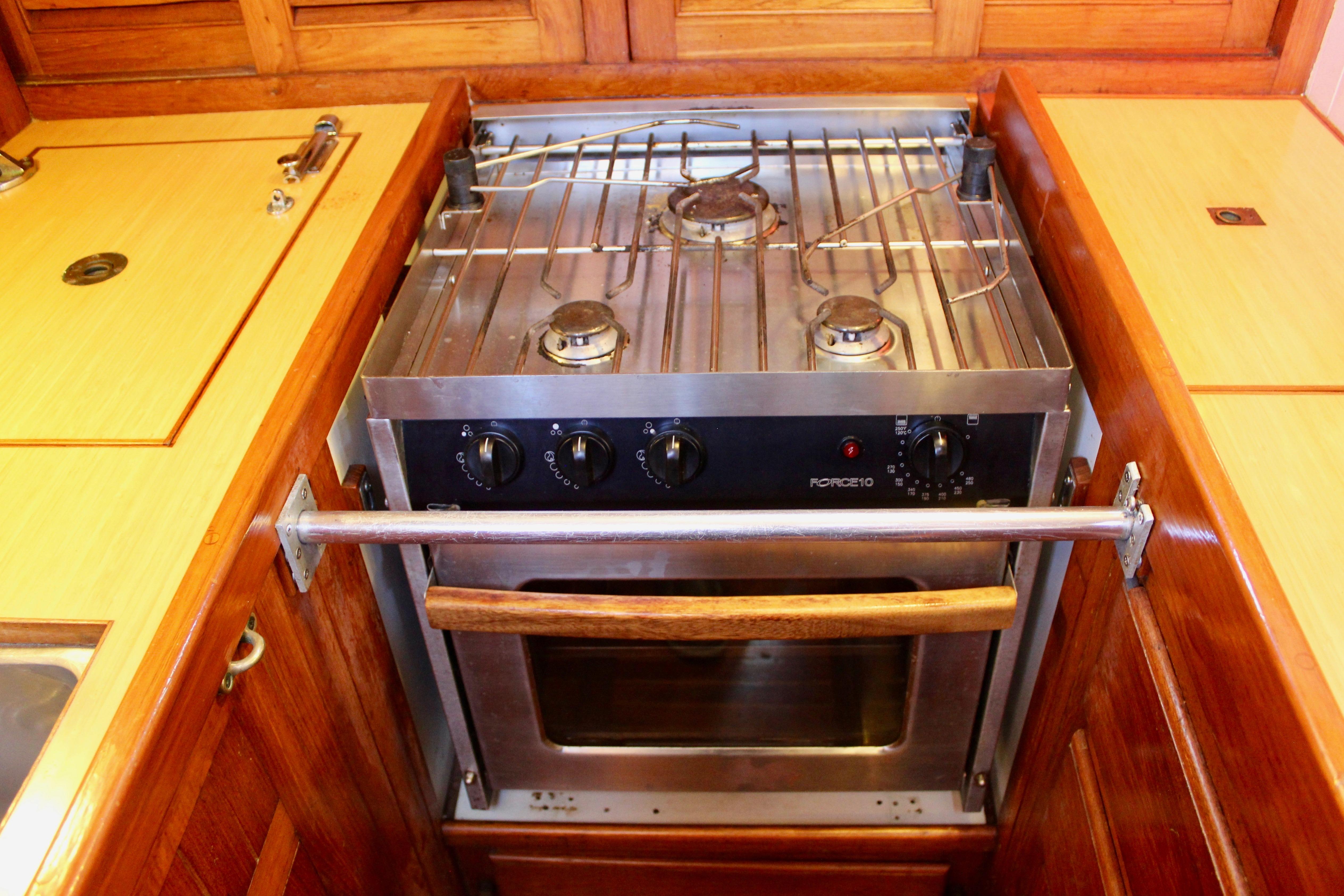 Stainless steel stove and oven in a 1981 Kelly Peterson 46 yacht kitchen.