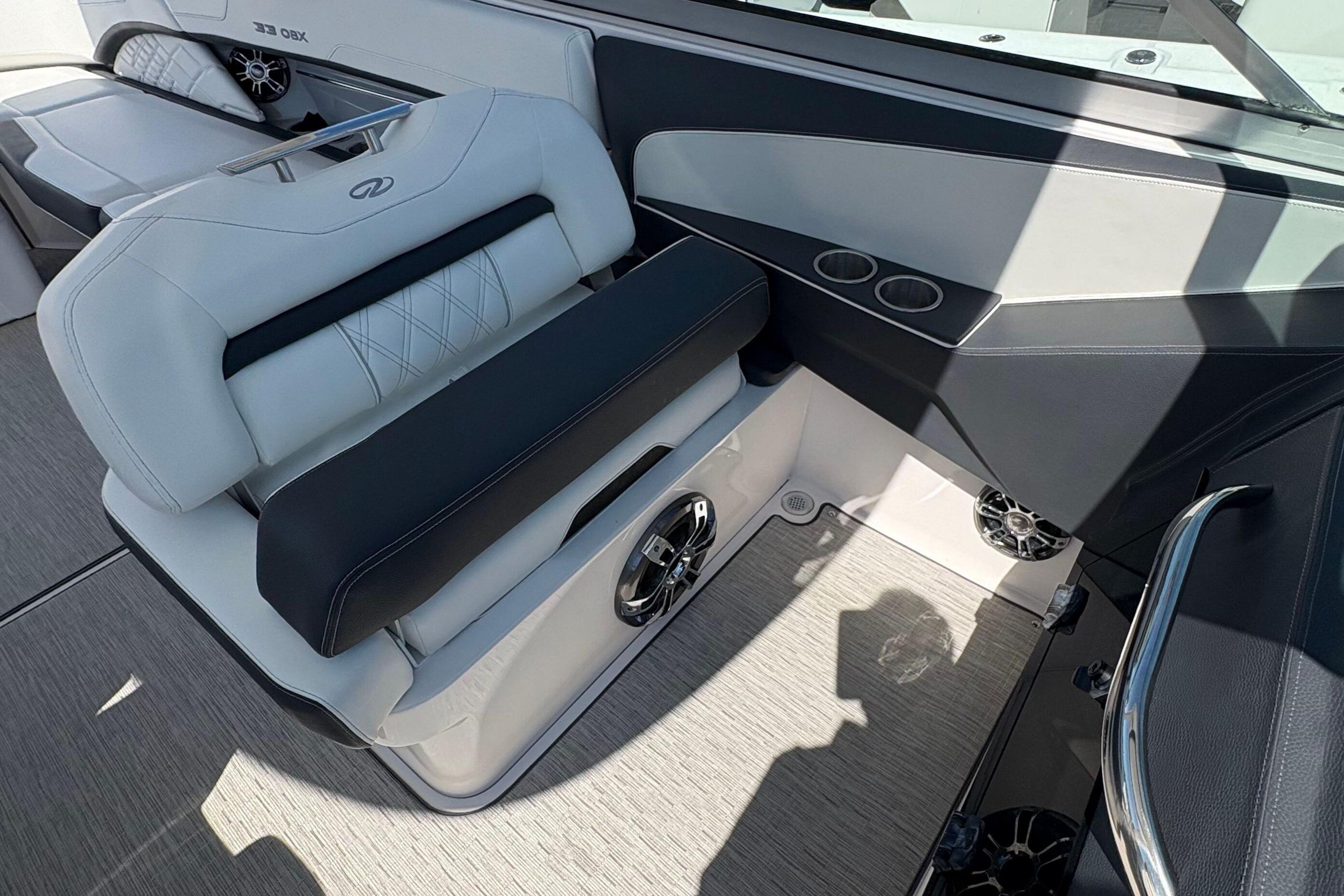 Interior of a 2020 Regal 33 OBX boat featuring luxurious seating and cup holders.