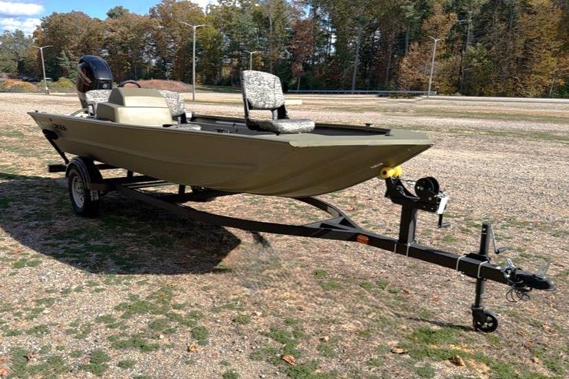 2026 Tracker Grizzly 1754 SC boat on trailer, parked outdoors on gravel.