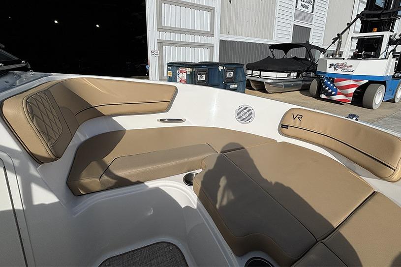 2023 Bayliner VR5 Bowrider OB with tan seating in a marina setting.