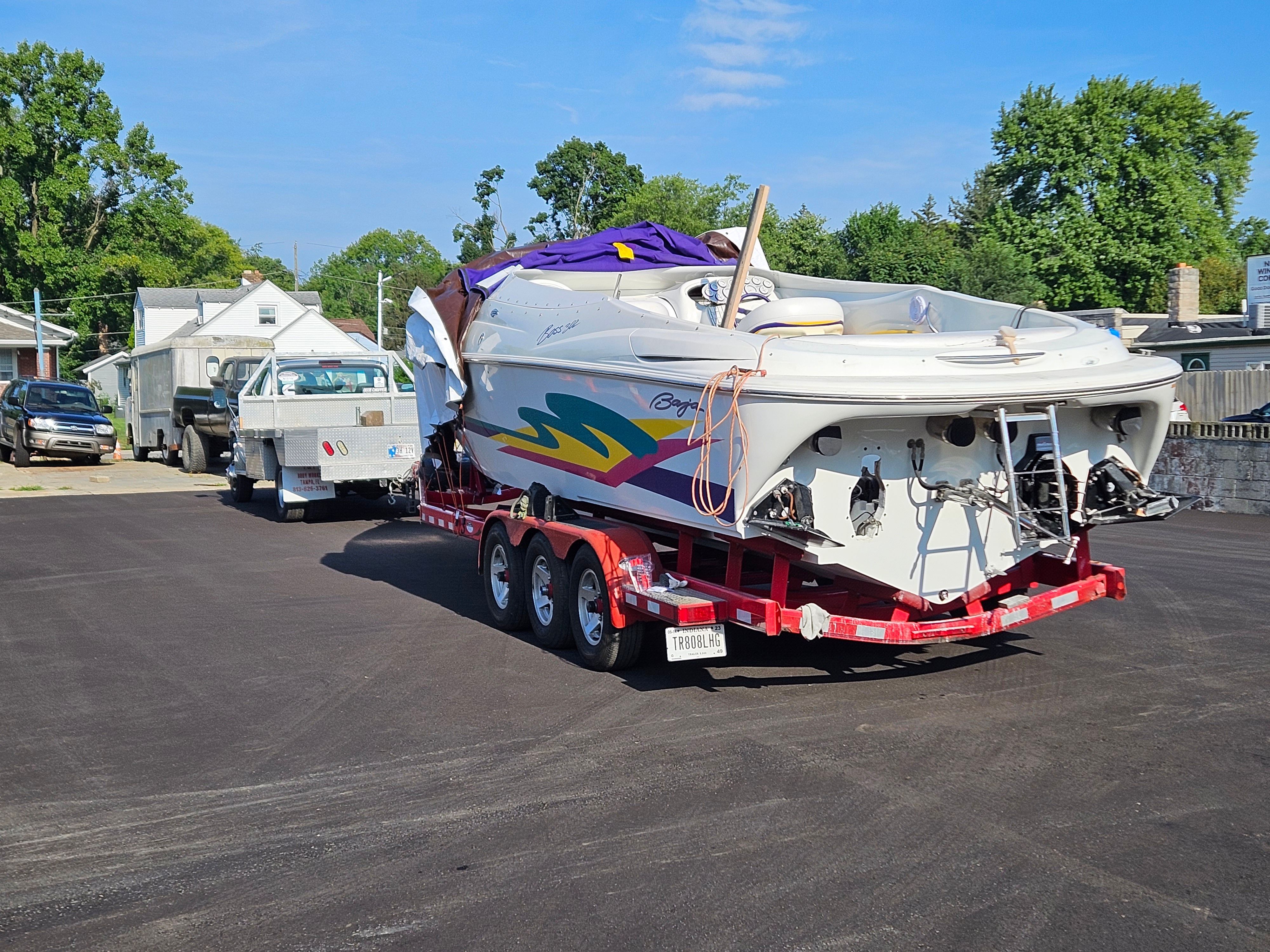 A 1996 Baja 302 Boss on a trailer, ready for transport. The sky is clear.