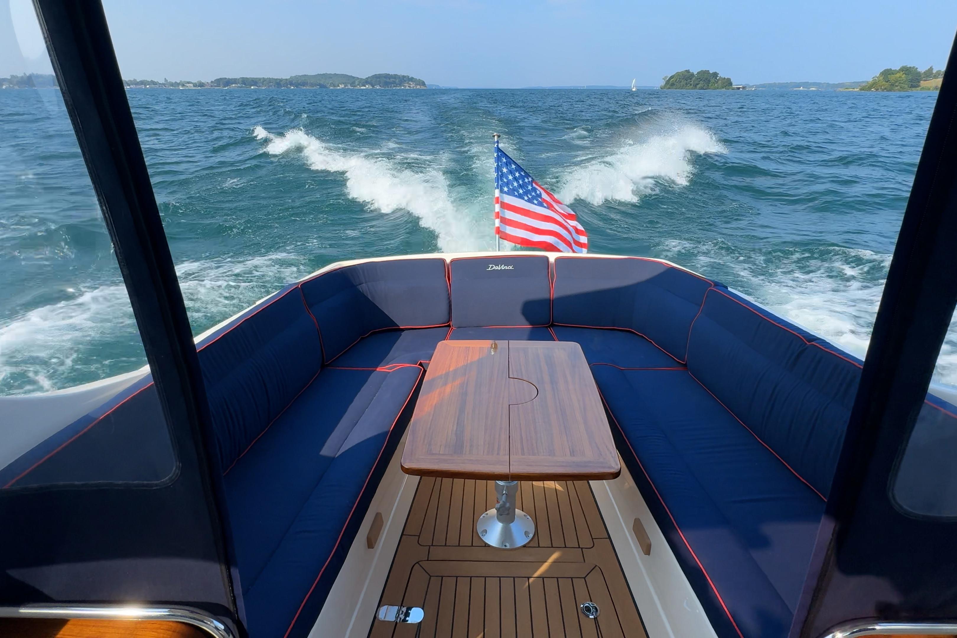 2024 DaVinci 30HT boat interior with American flag, cruising on open water.