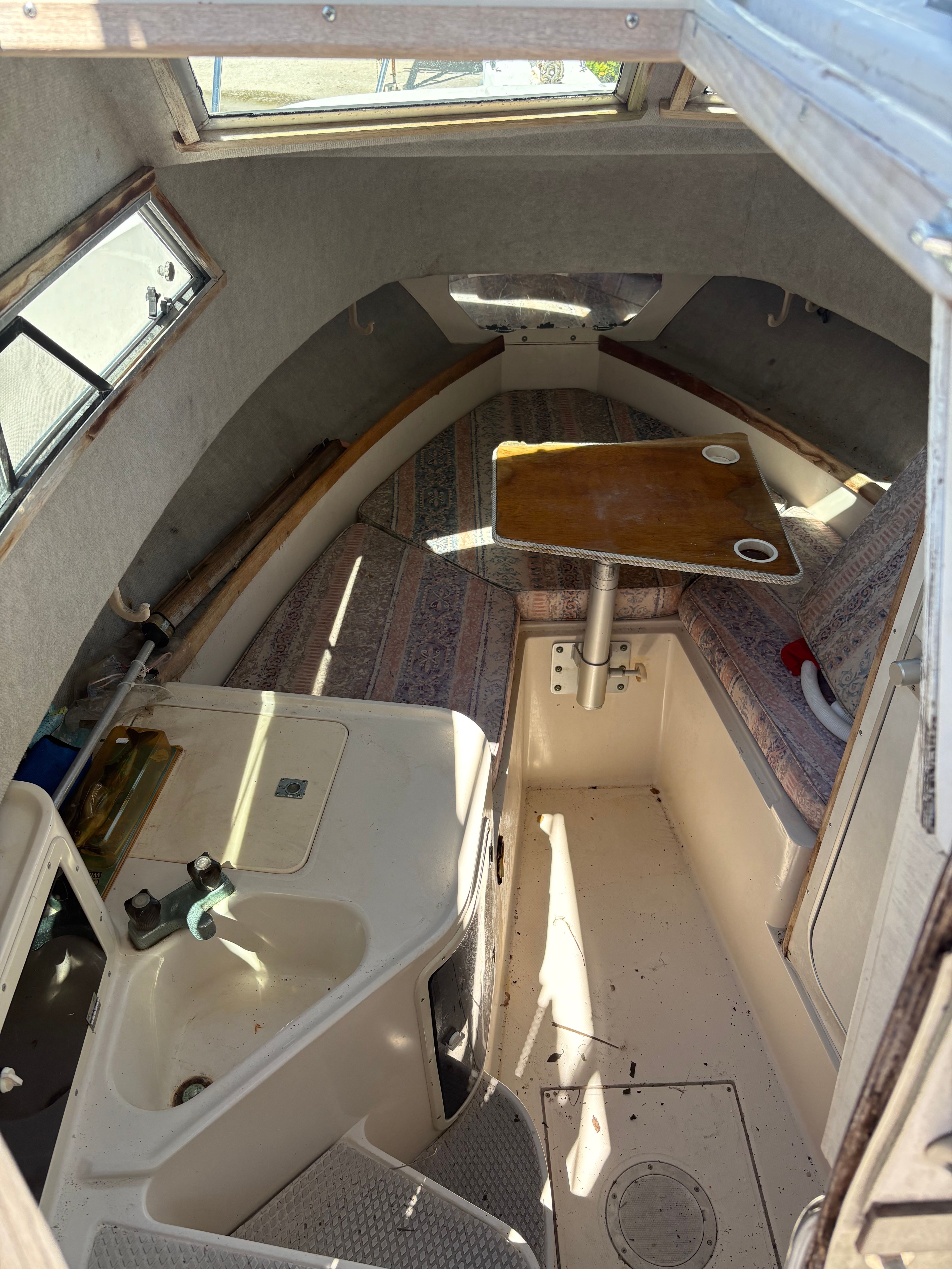 Interior of a 1990 Grady-White Sailfish with seating area and small table.