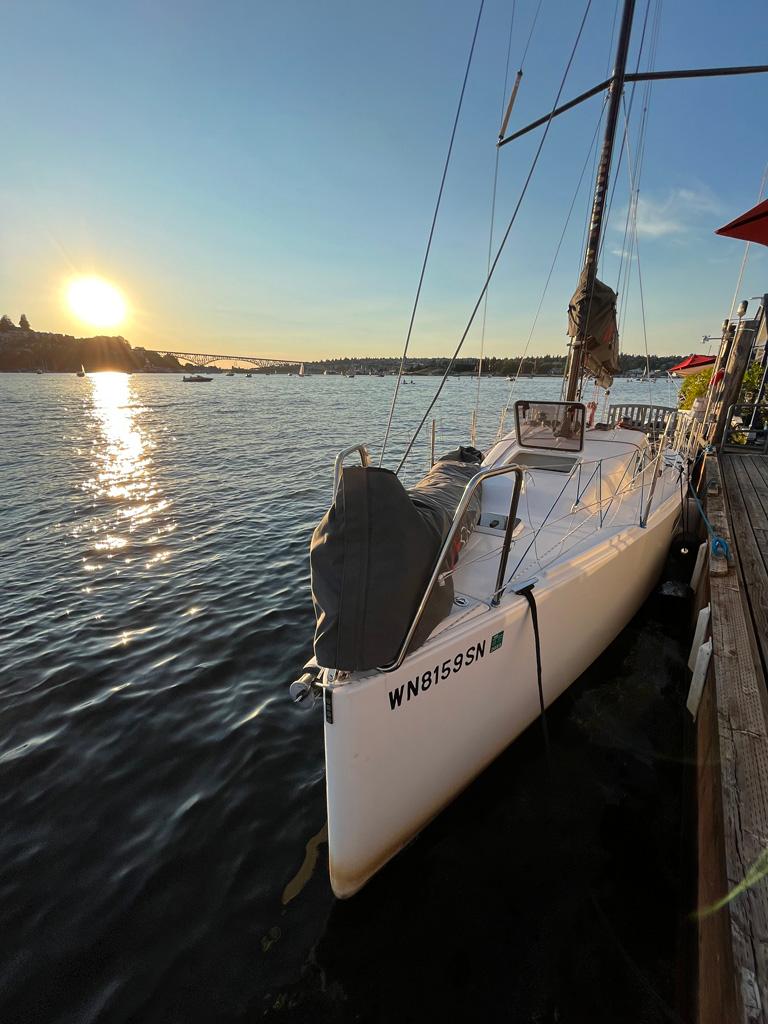 Sailboat Seascape 27 docked at sunset, reflecting on calm water, 2018 model.