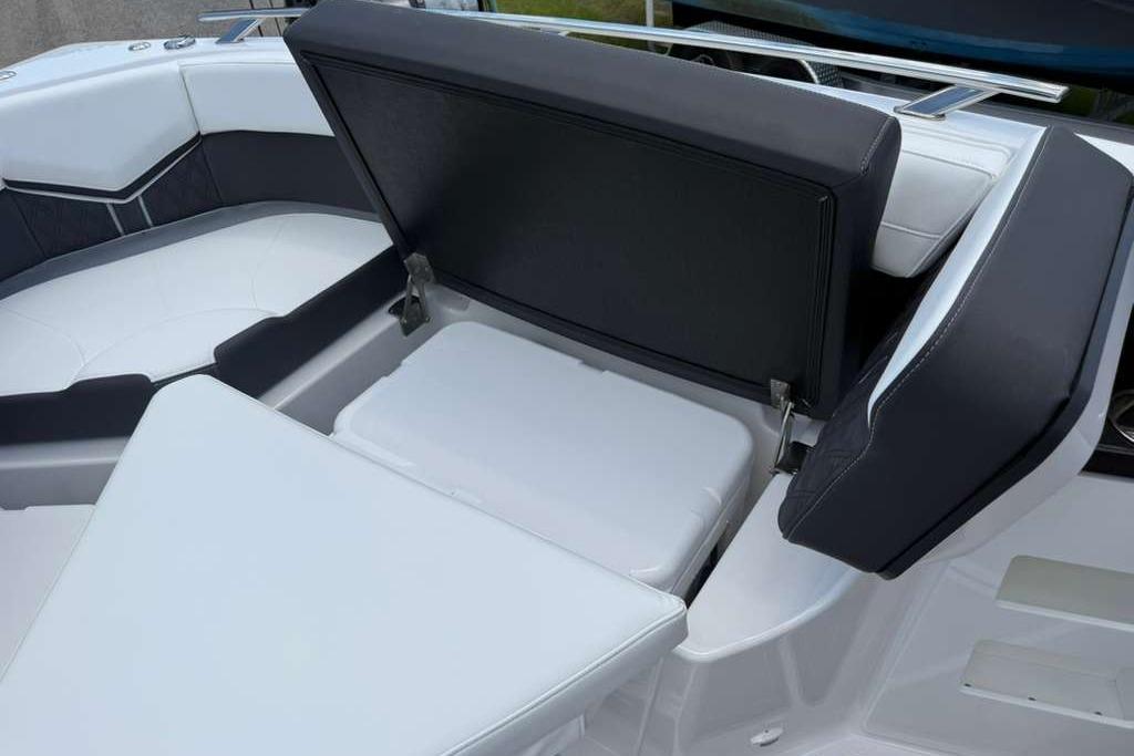 2026 Monterey Elite 30 OB boat interior with open storage compartment and cushioned seating.