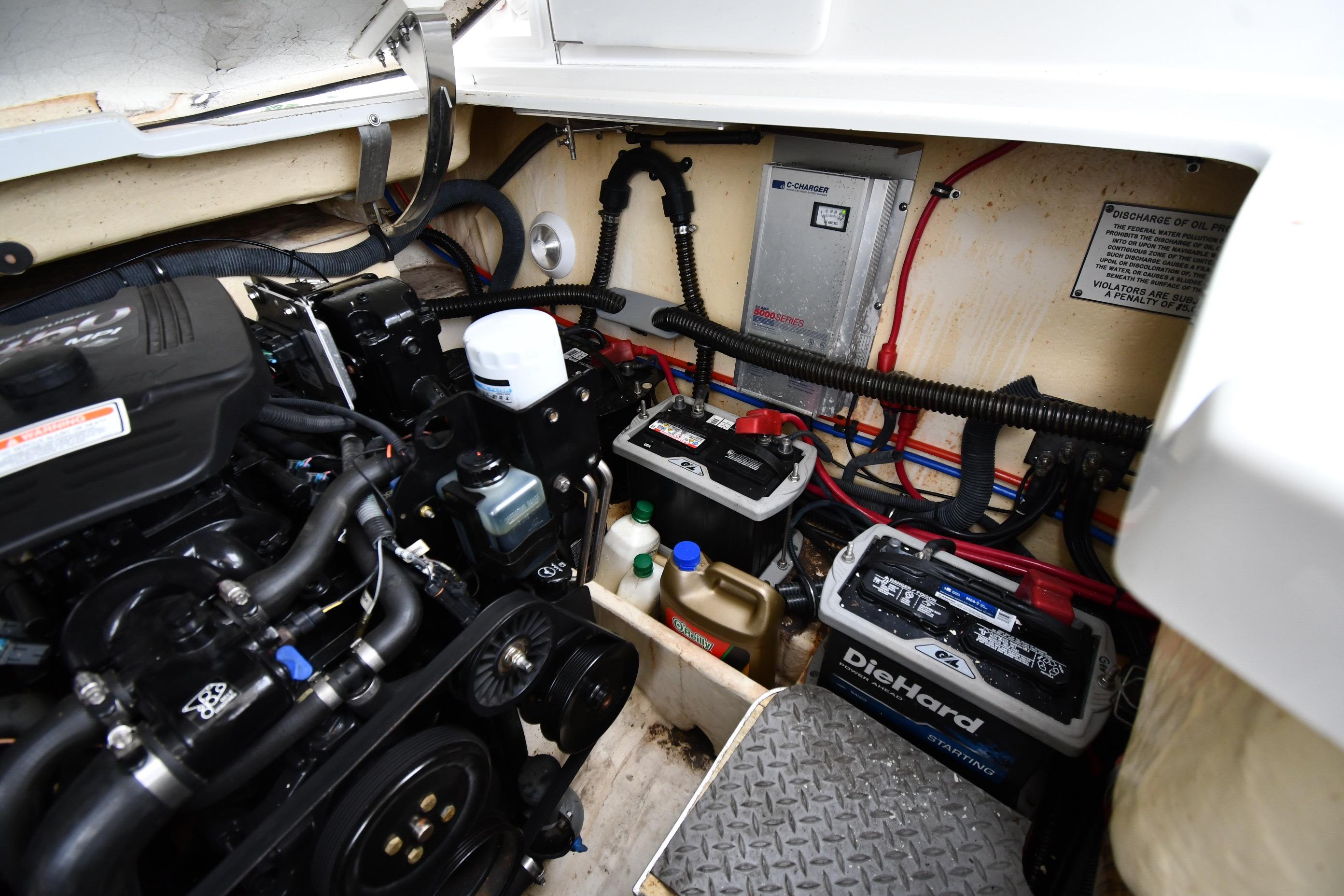 Engine compartment of a 2004 Formula 330 Sun Sport boat with batteries and wiring.