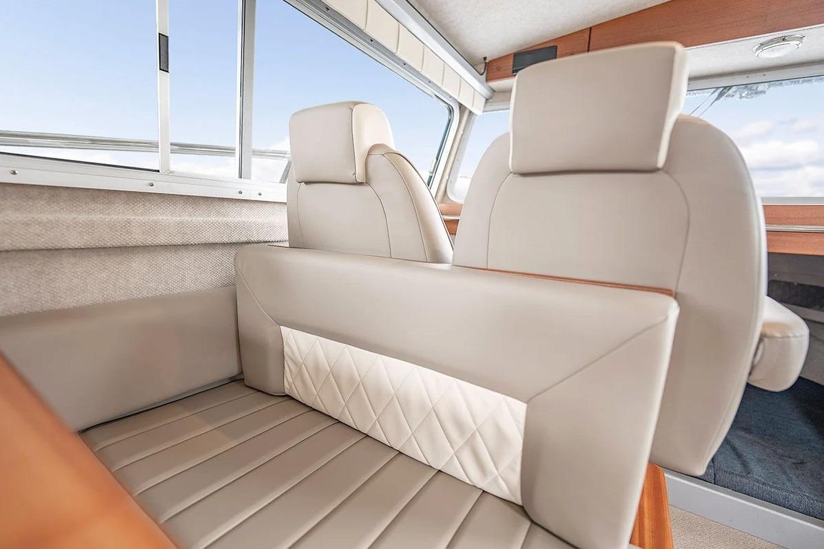 Luxurious interior seating of 2026 KingFisher 3225 GFX Offshore boat, featuring elegant beige upholstery.