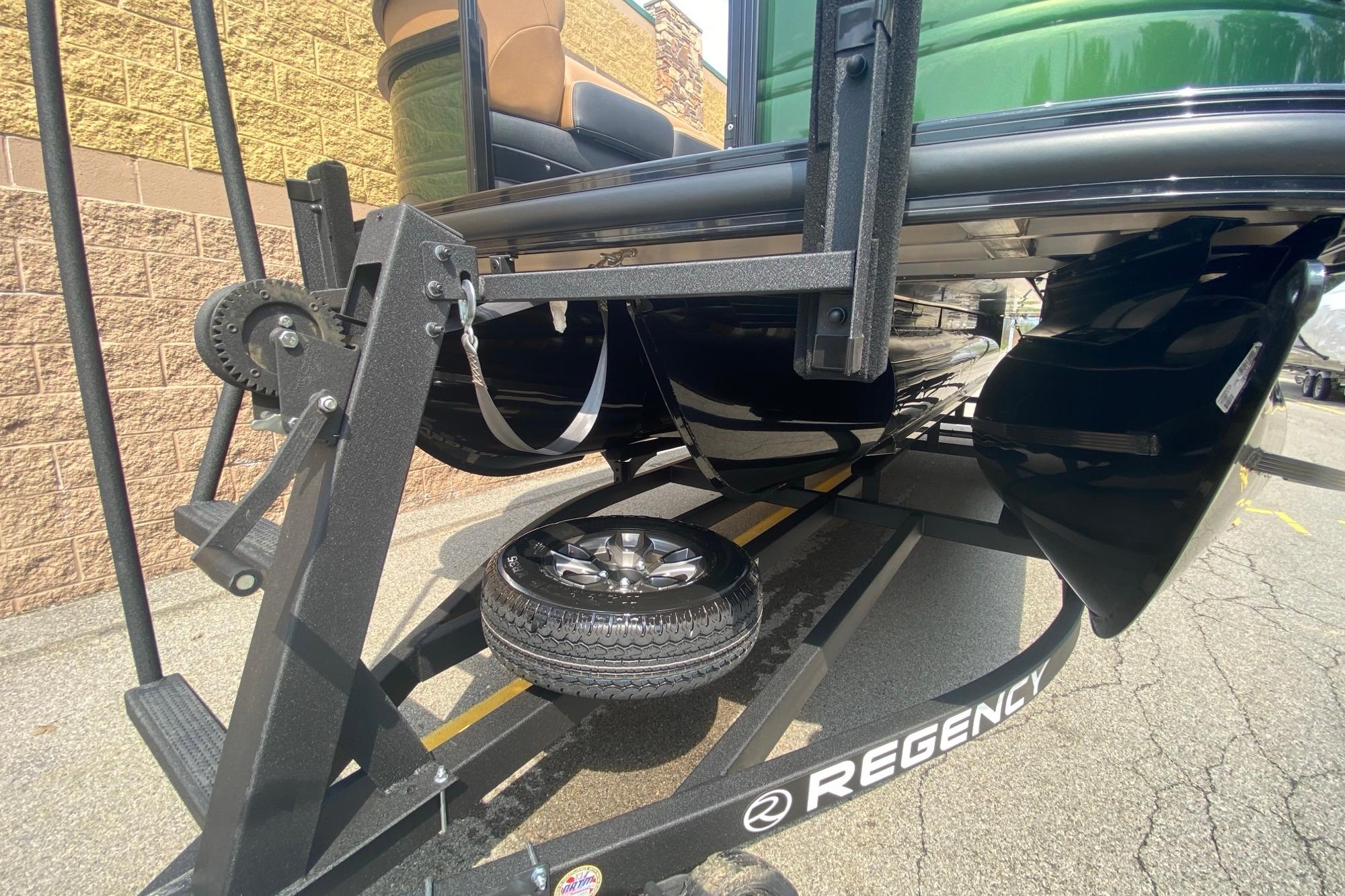 2026 Regency 230 DL boat on trailer, showcasing undercarriage and wheel detail.