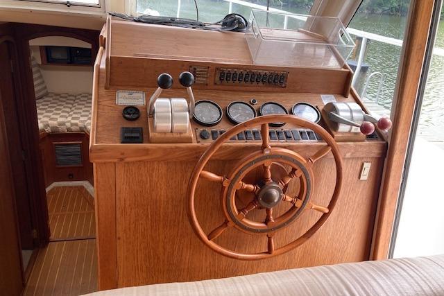 Helm of 2000 Mainship 430 Trawler with wooden wheel and control panel.