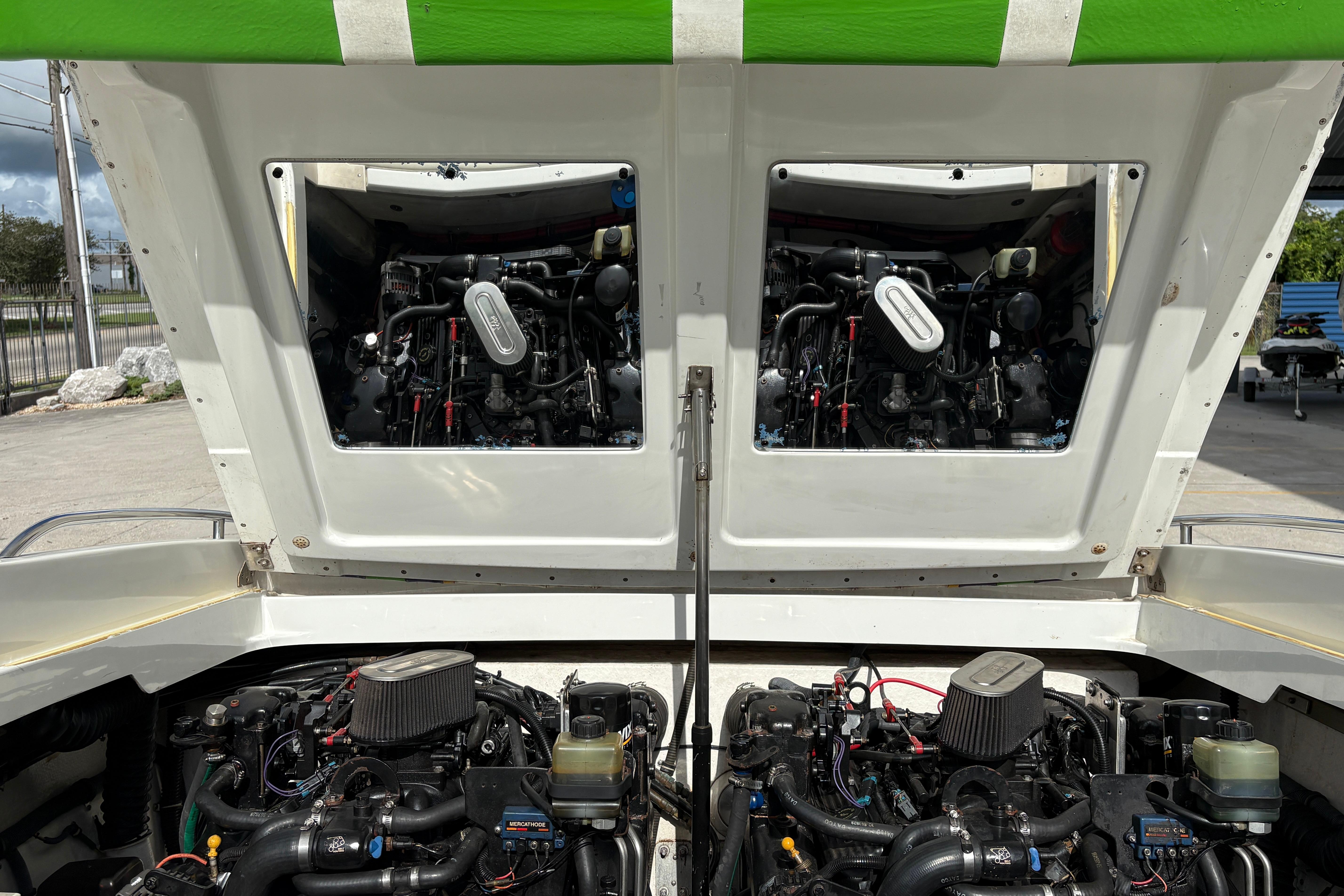 2002 Formula 292 FASTech boat engines exposed under open hatch, showcasing dual power systems.